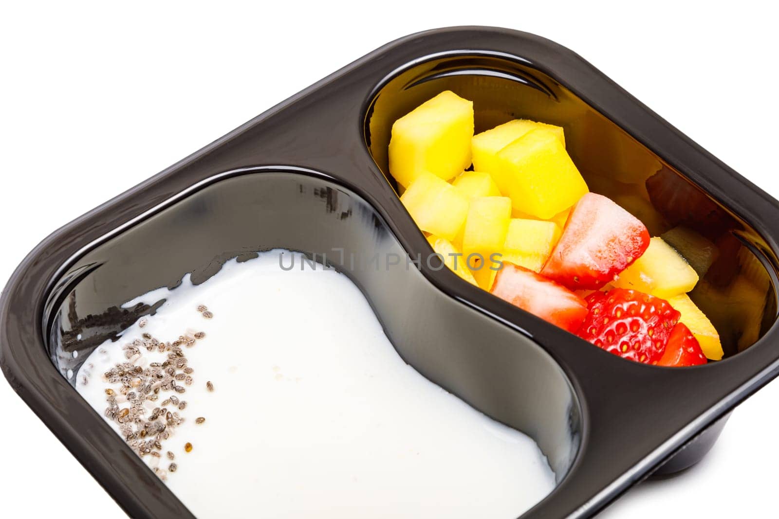 Portion of yogurt dessert with strawberry and mango in a plastic bowl. High quality photo