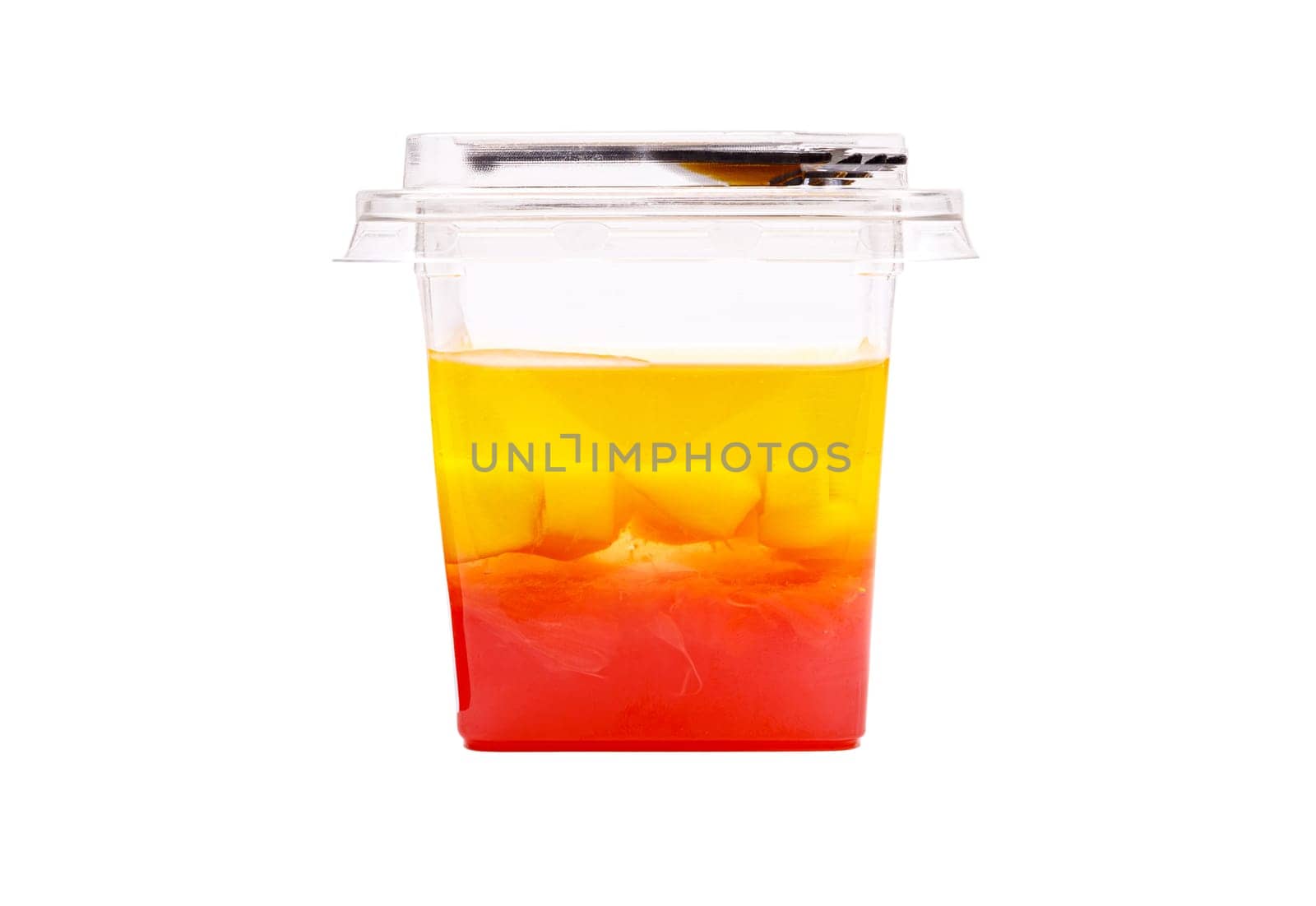 Grapefruit, mango and raspberry jelly in a plastic cup on a white background. High quality photo. Side view.