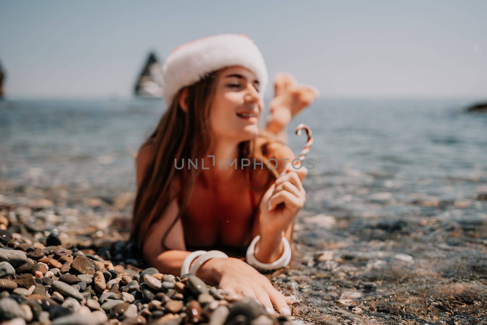 Woman travel sea. Happy tourist taking picture outdoors for memories. Woman traveler looks at the edge of the cliff on the sea bay of mountains, sharing travel adventure journey.