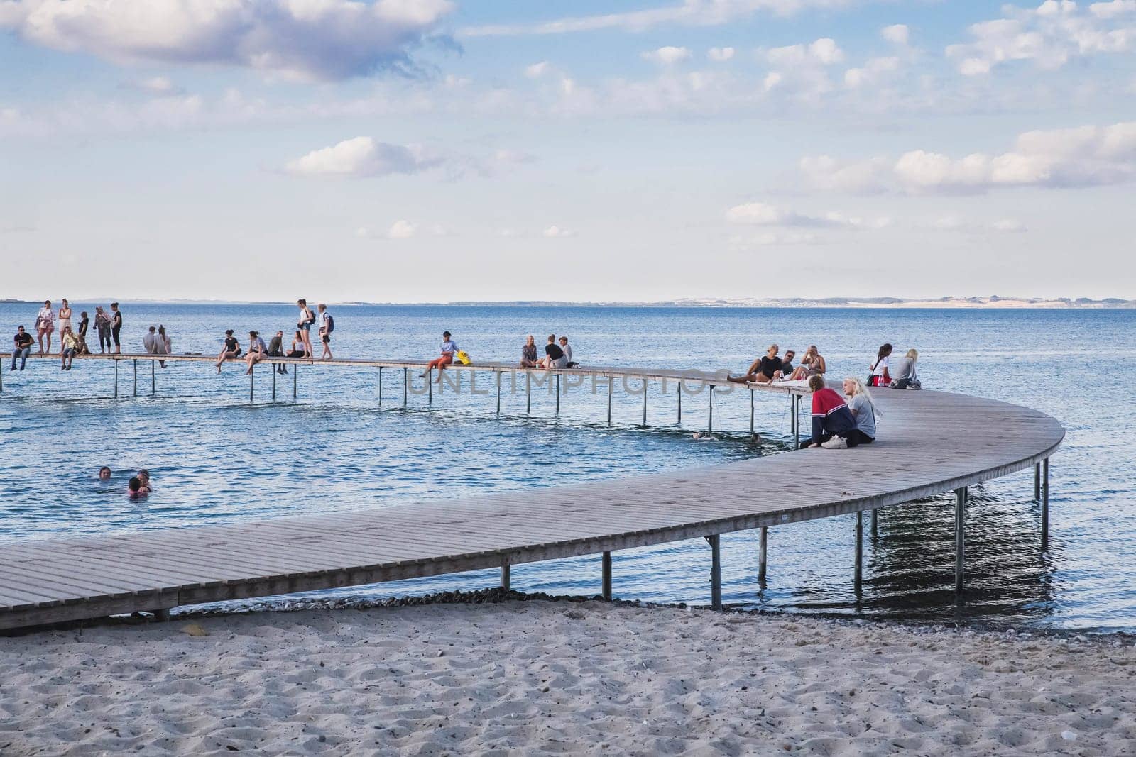 Aarhus, Denmark, July 2018: people rest on a round pier in Denmark.