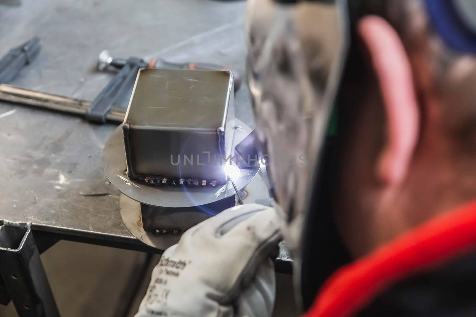 employee works by Semi-automatic argon welding at the factory.