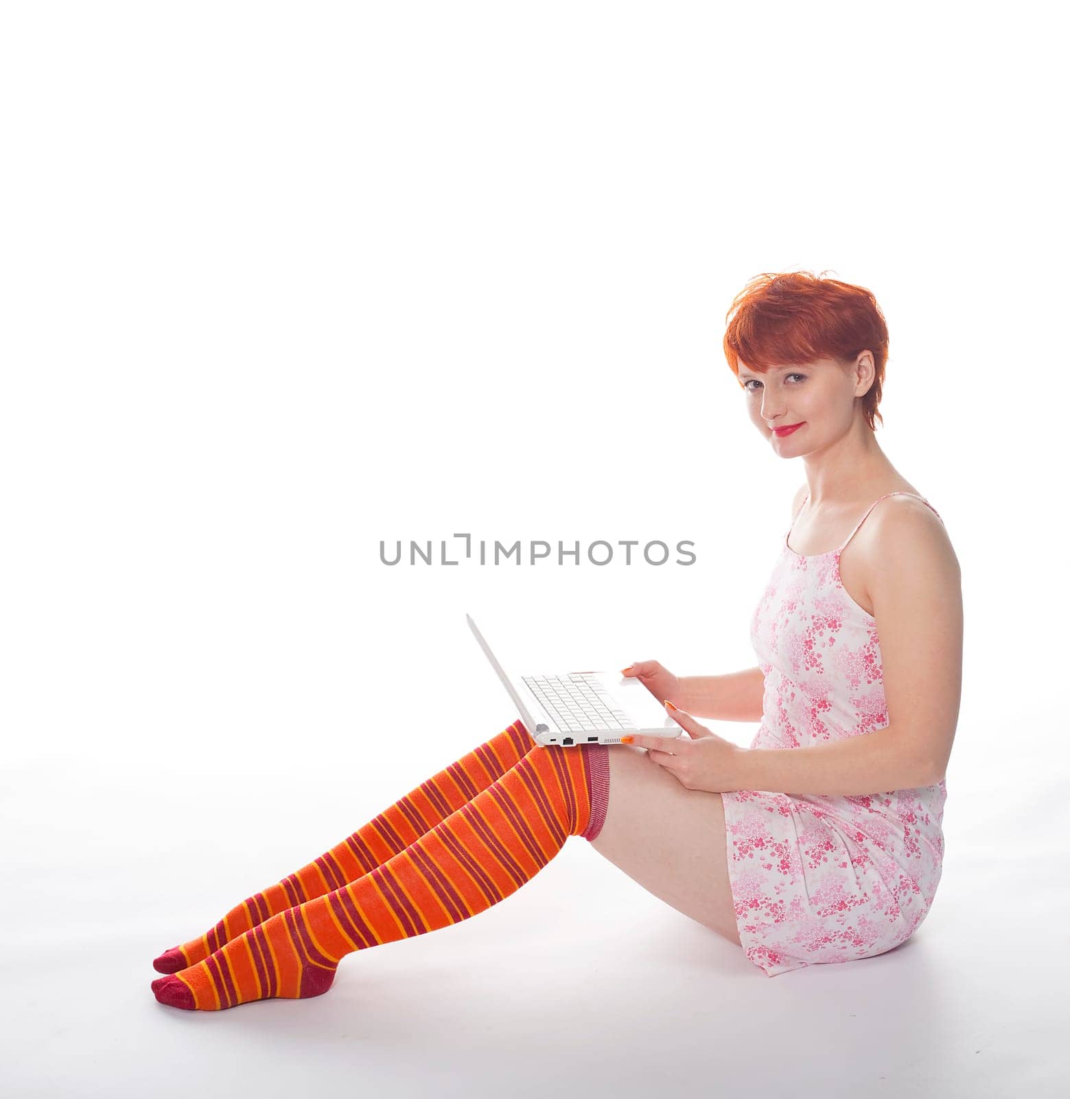 Red Girl in stripe socks with laptop on white background