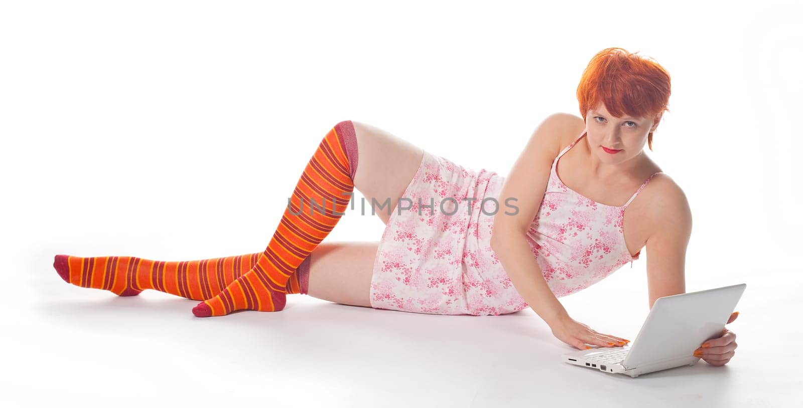 Red Girl in stripe socks with laptop on white background