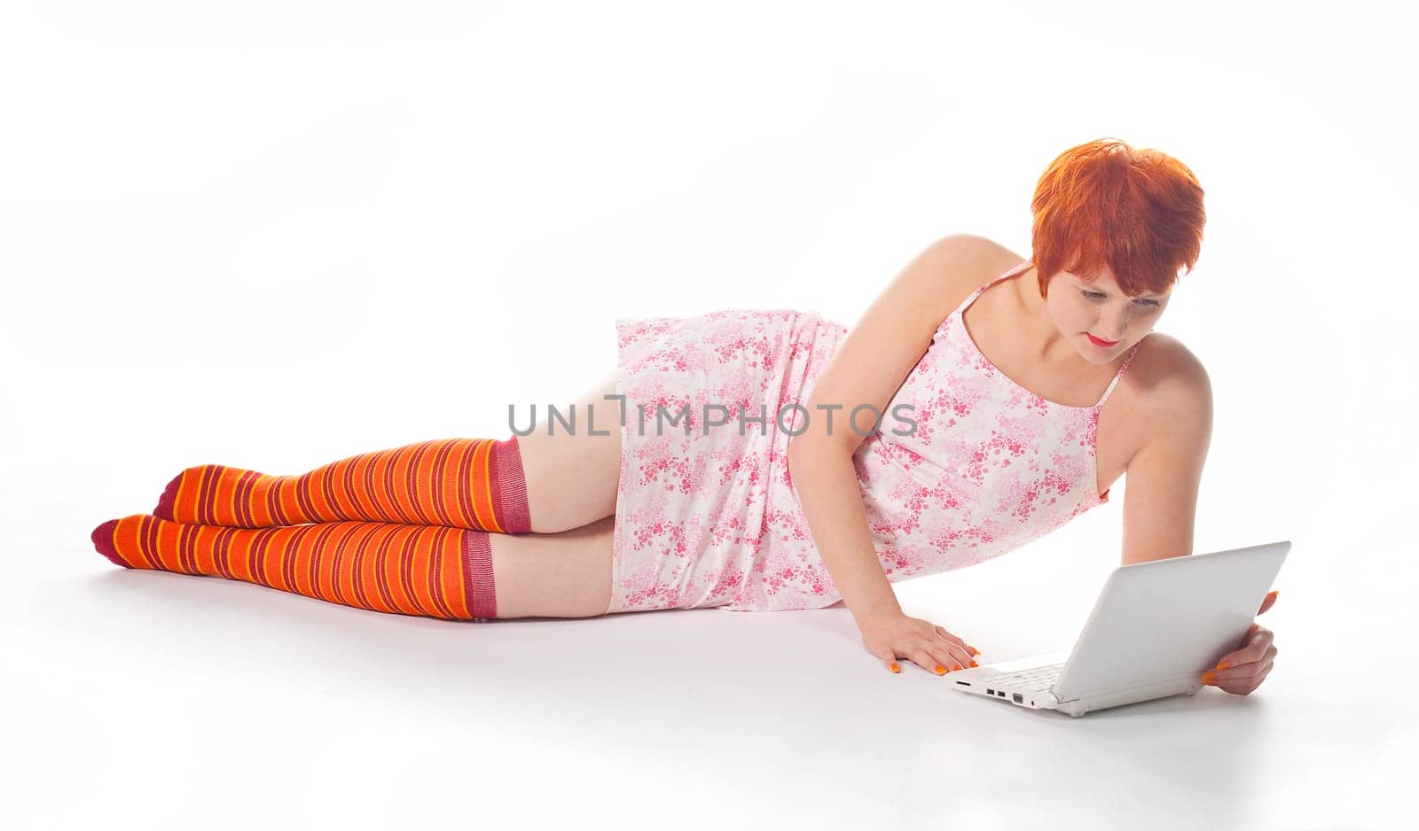 Red Girl in stripe socks with laptop on white background