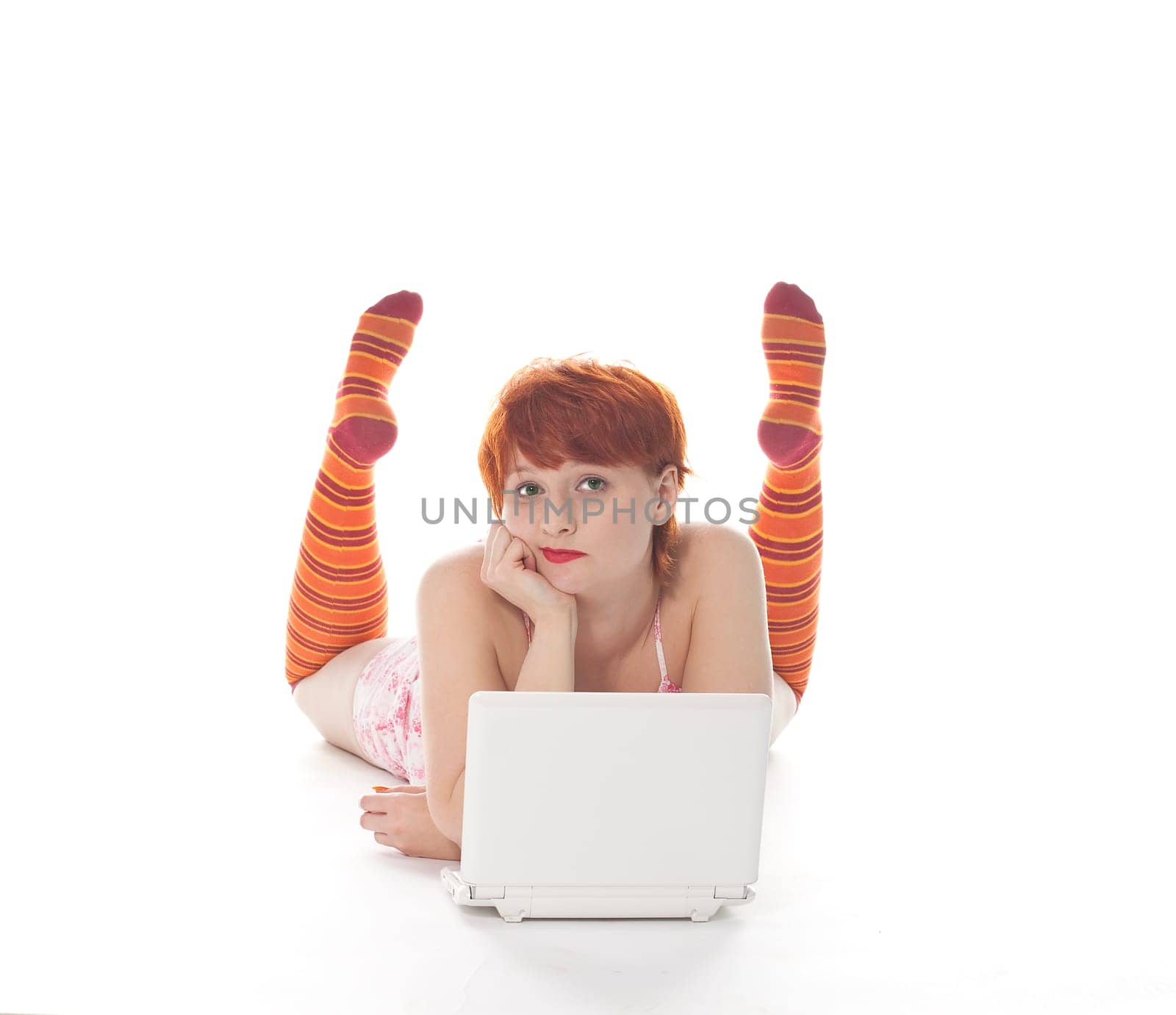 Red Girl in stripe socks with laptop on white background