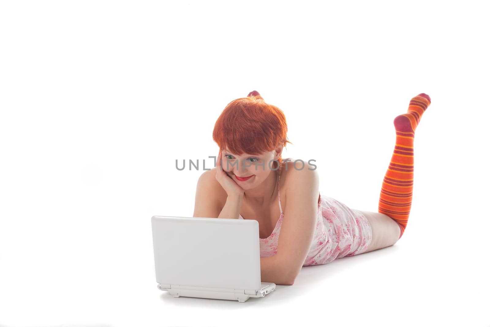 Red Girl in stripe socks with laptop on white background