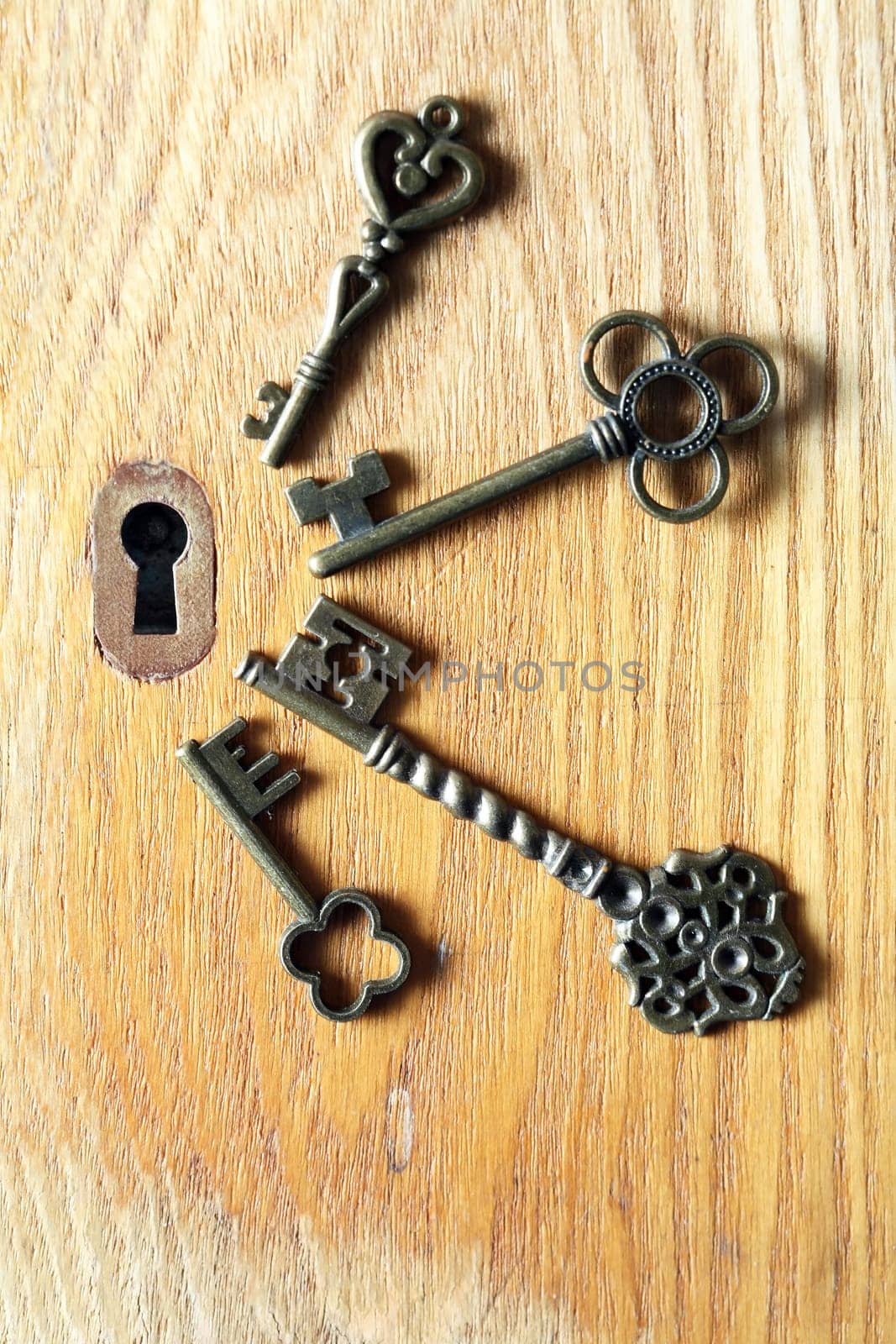 Set of various old keys closeup near keyhole