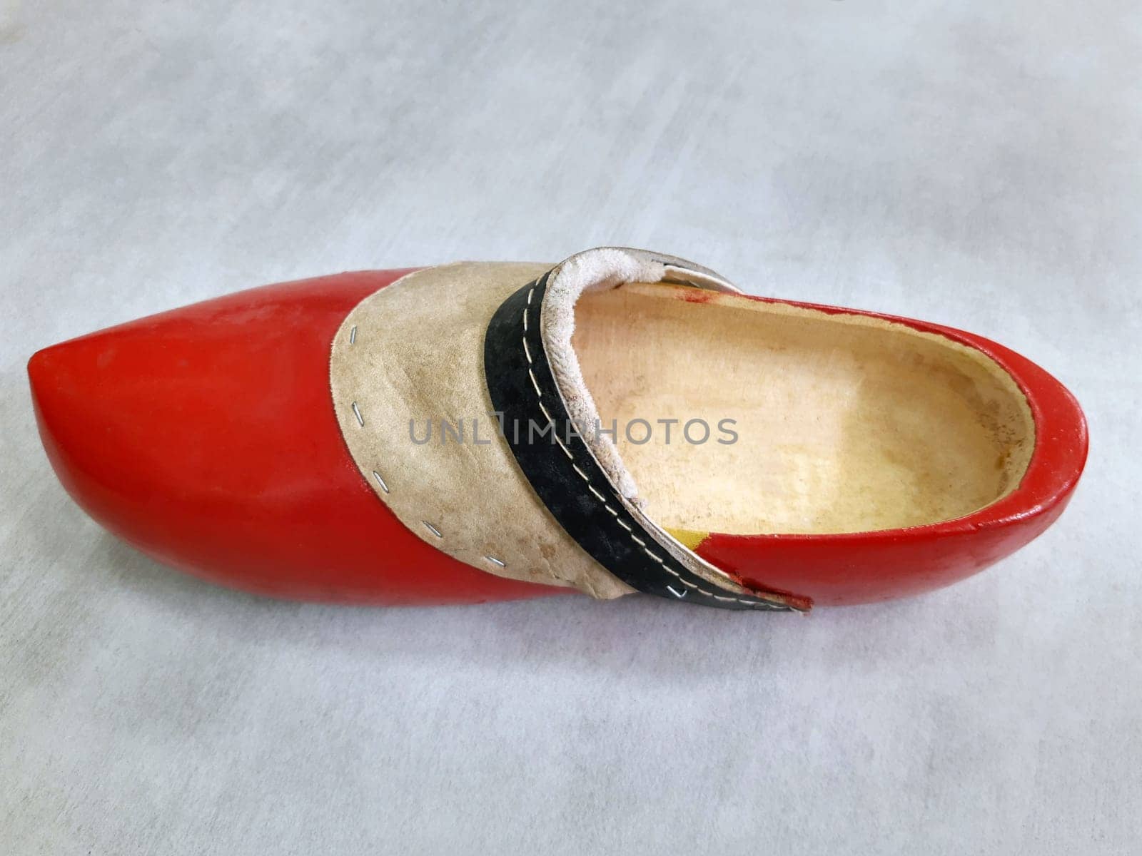 Big red dutch wooden shoe close up. Wooden shoe.