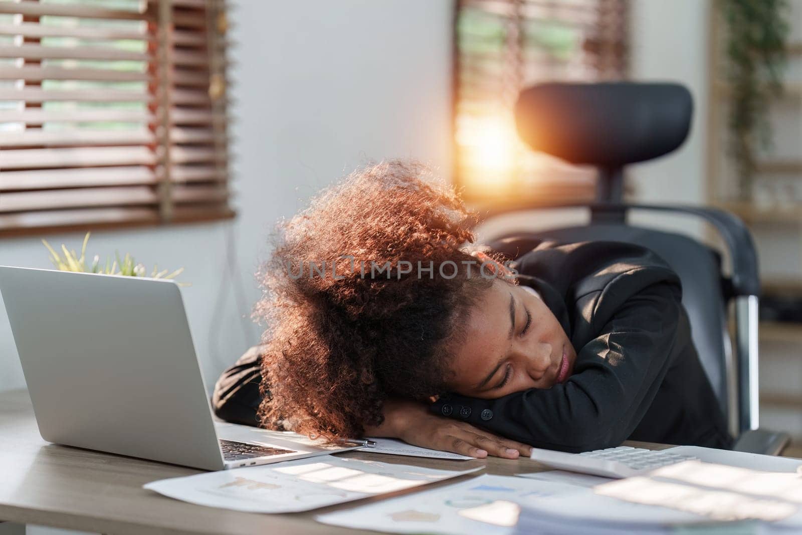 Tired American African business woman in stress works with many paperwork document. migraine attack. Freelance, work from home.