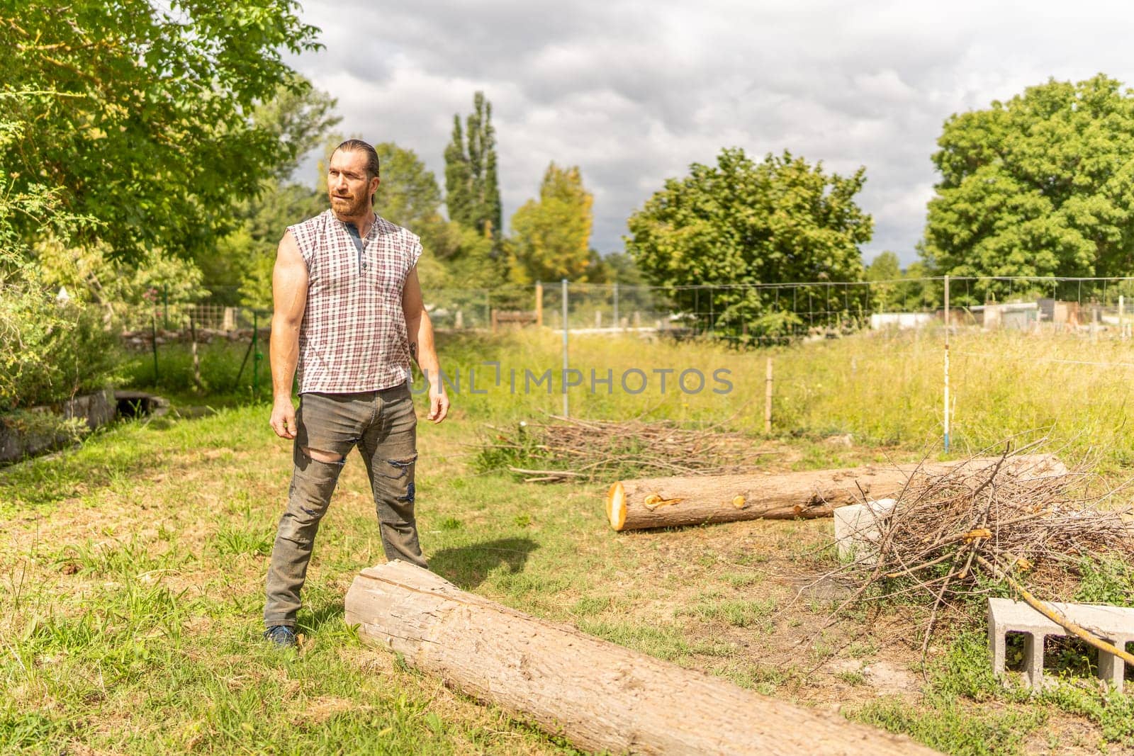 Portrait of a woodcutter standing with casual clothes in a orchid