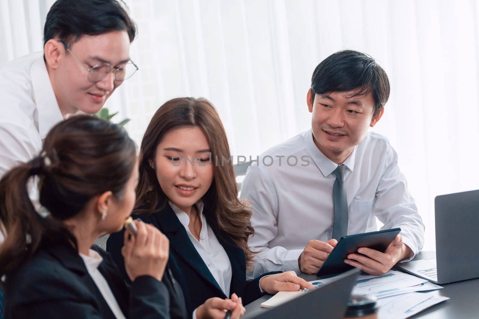 Office worker and manager analyze financial report paper in harmony workplace. by biancoblue