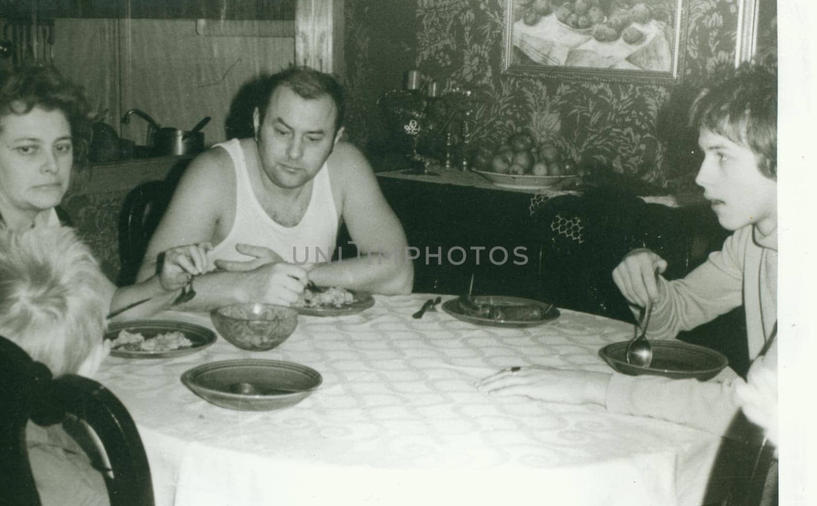 USSR - CIRCA 1970s: Retro photo shows family during lunchtime. Vintage black and white photography.