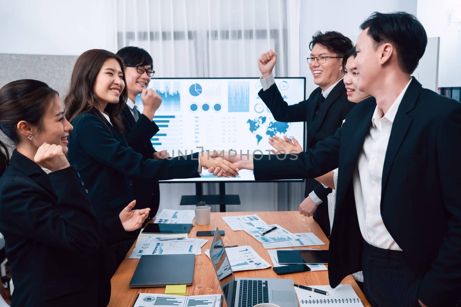 Businesspeople shake hand after successful agreement or meeting. Office worker colleague handshake with business team leader manager for strong teamwork in office to promote harmony and unity concept.