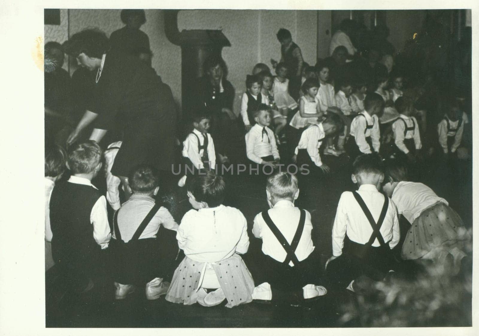 Retro photo shows small pupils in the classroom. Vintage black and white photography. by roman_nerud