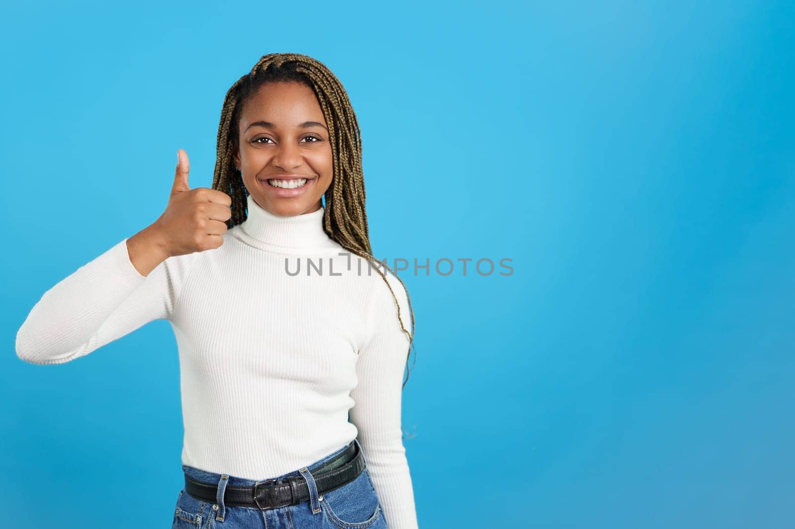 African woman gesturing positively with the thumb up by ivanmoreno