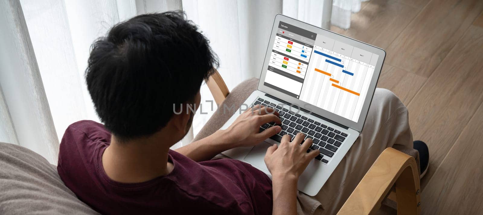 Project planning software for modish business project management on the computer screen showing timeline chart of the team project