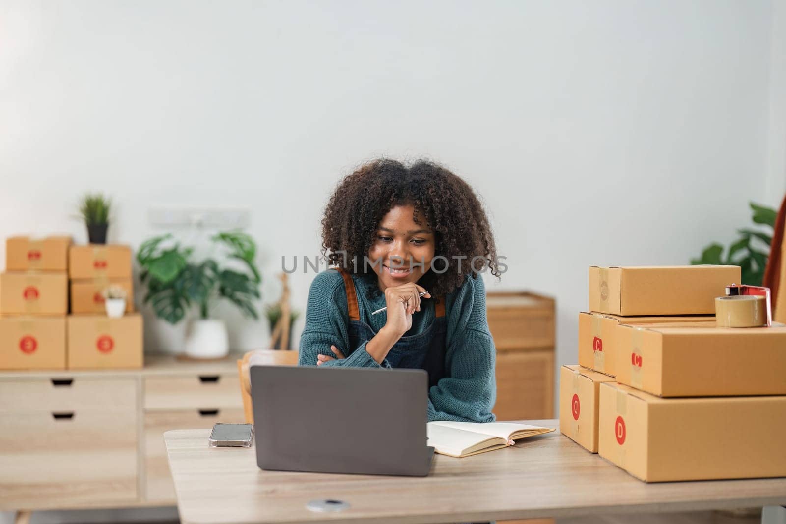 Entrepreneur, small business, SME, freelance woman working from home with lots of boxes on the side. Use smartphones and laptops for commercial monitoring. online marketing packaging box online sale.