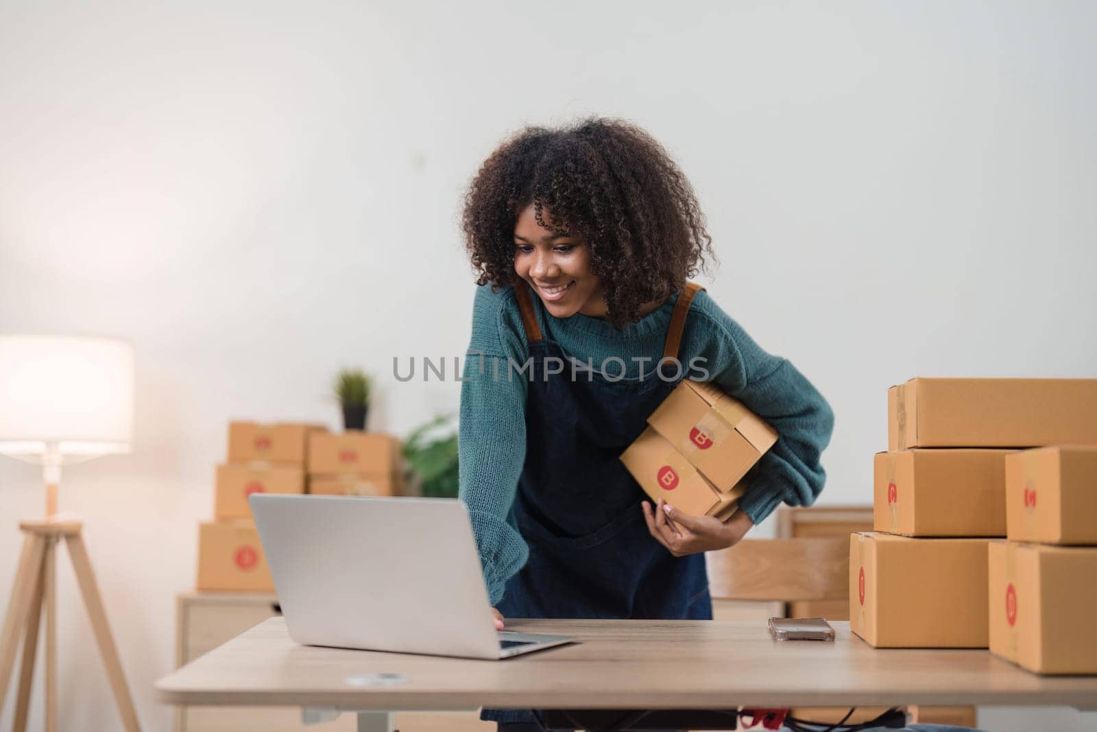 Young attractive woman owner startup business work happy with box at home prepare parcel delivery in sme supply chain, online delivery idea concept.