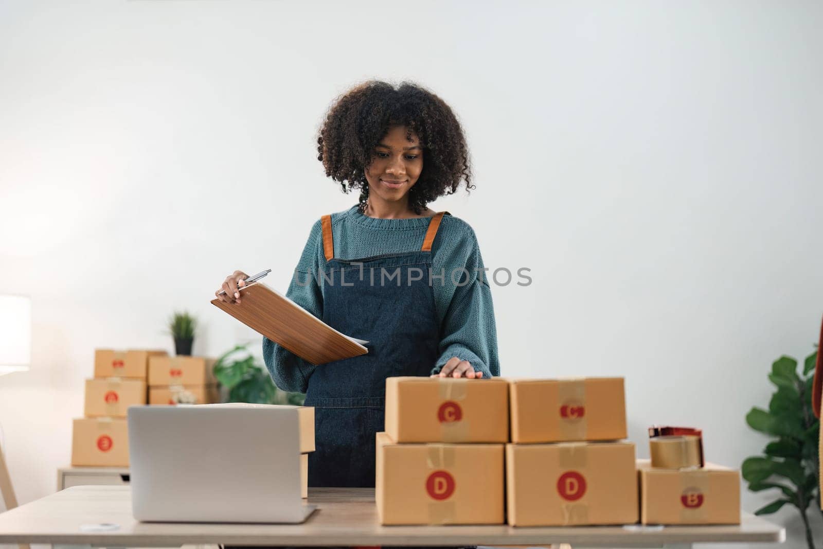 Young attractive woman owner startup business work happy with box at home prepare parcel delivery in sme supply chain, online delivery idea concept.