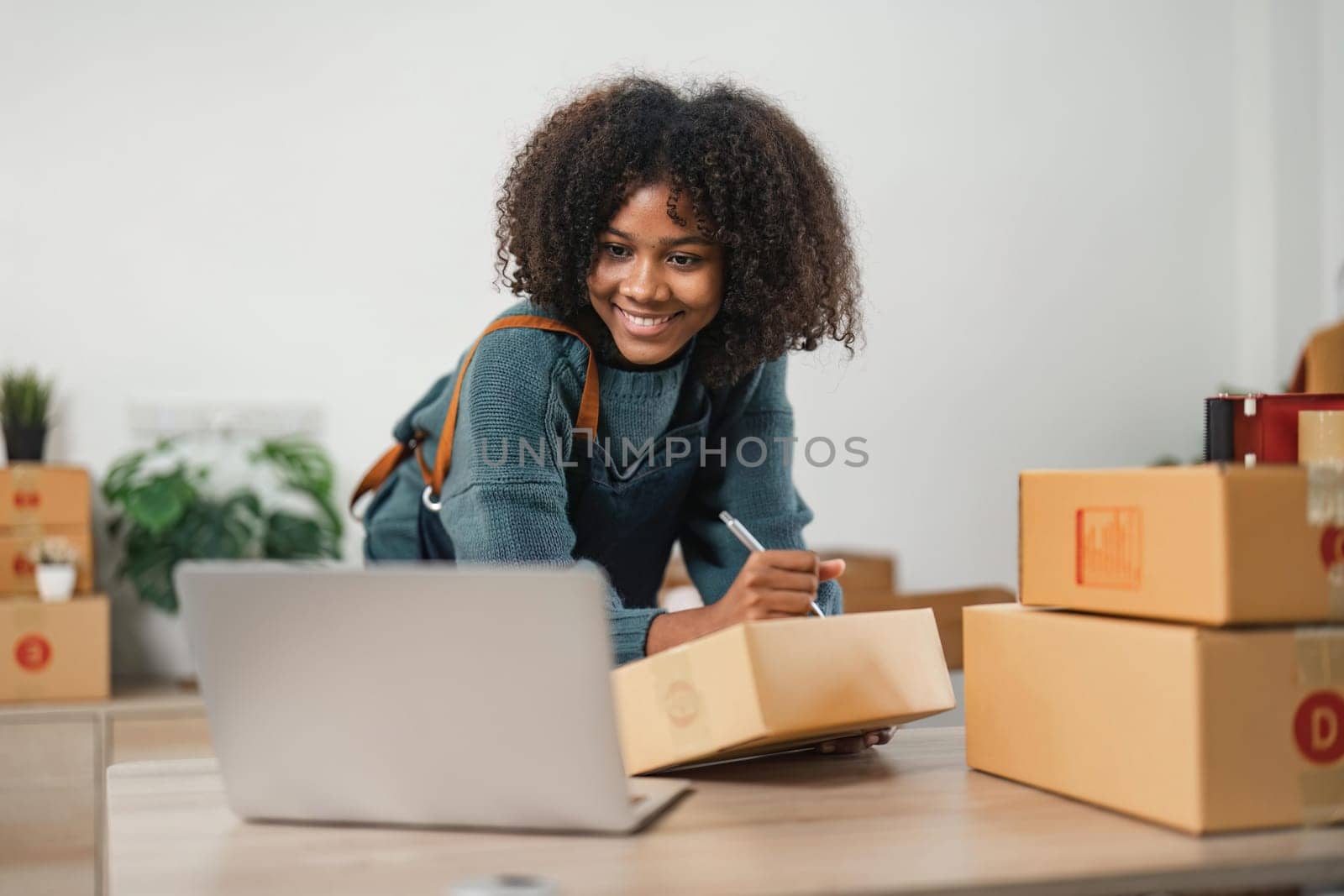 Young attractive woman owner startup business work happy with box at home prepare parcel delivery in sme supply chain, online delivery idea concept by nateemee