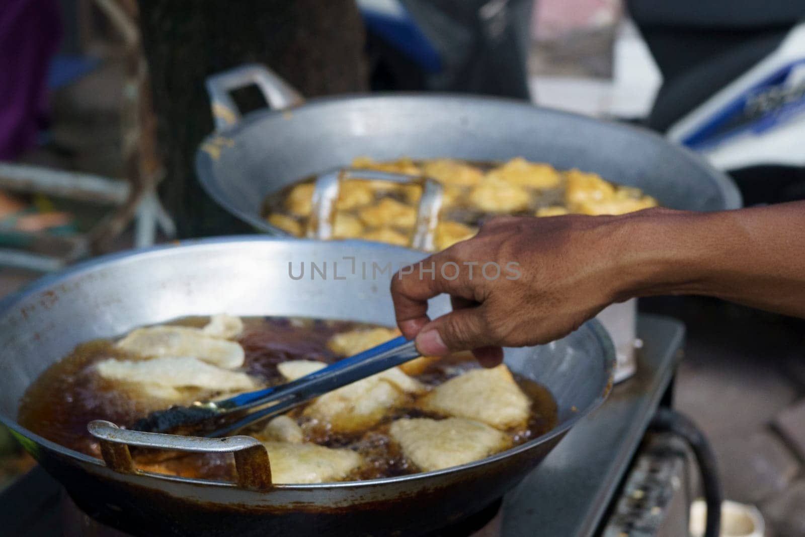 Pan Frying process of the Indonesian street vendors for the meals as the breakfasting time in Ramadhan.
