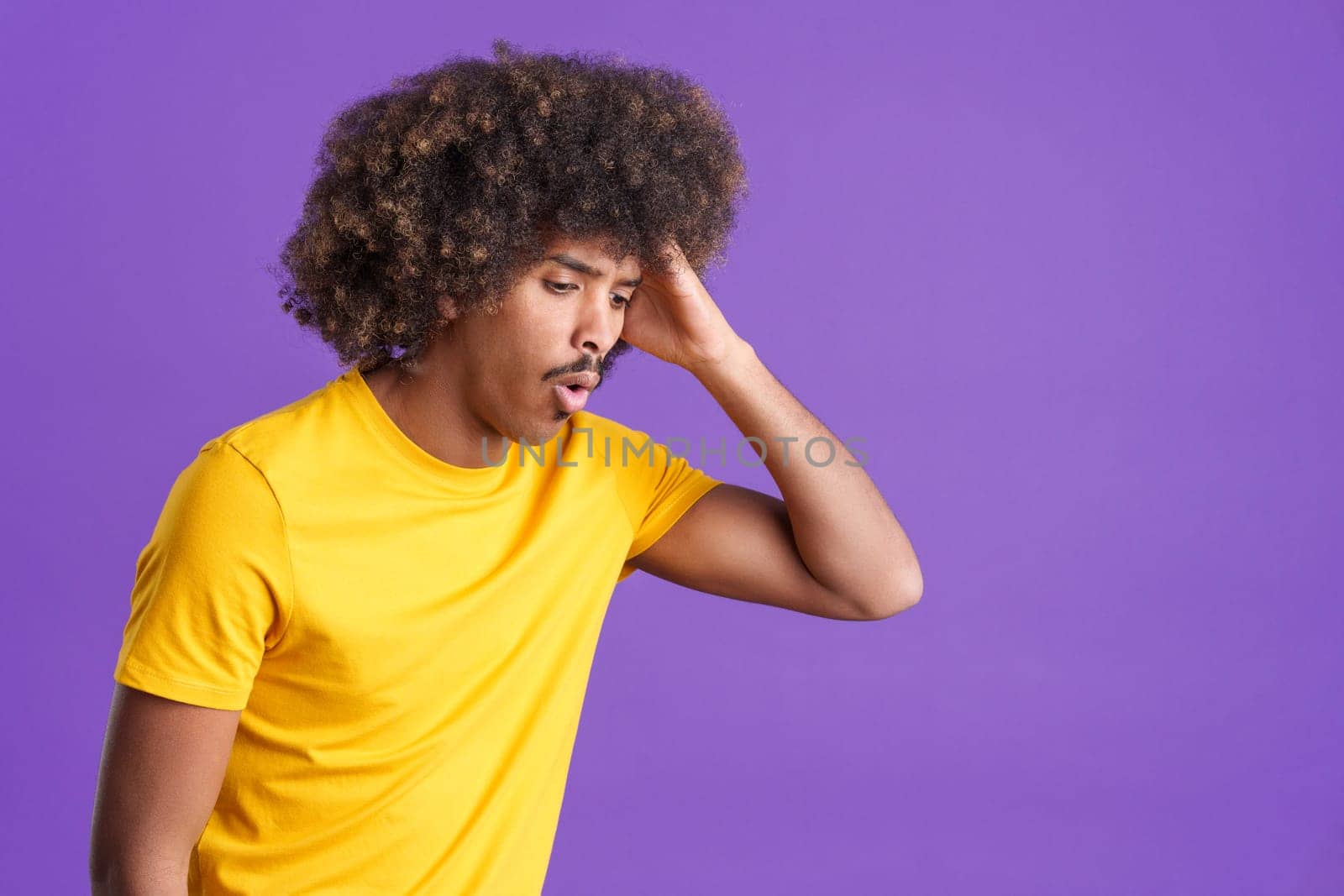 Desperate african man gesturing that he is forgetting something in studio
