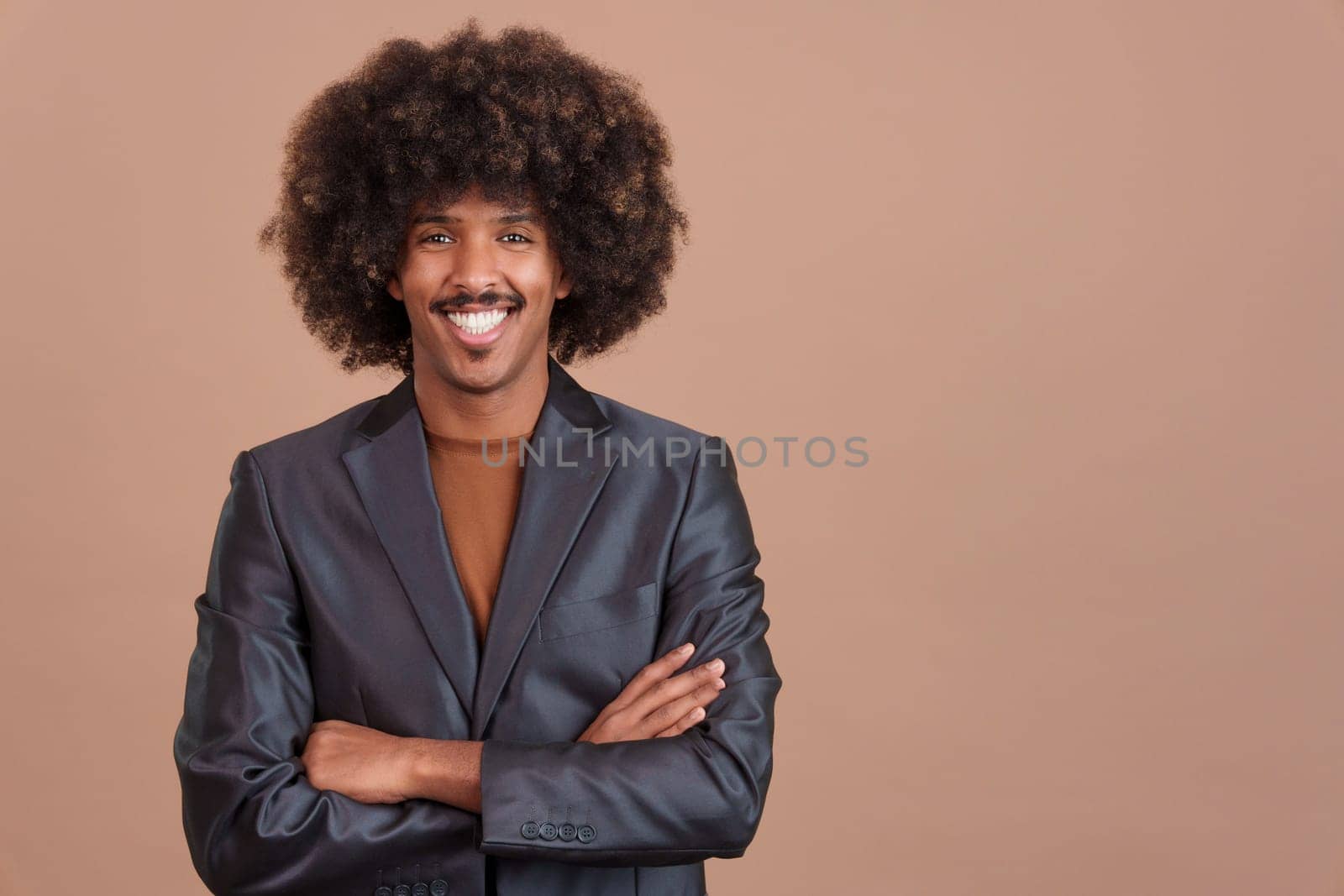 Smiley stylish african man with a black jacket looking at camera in studio