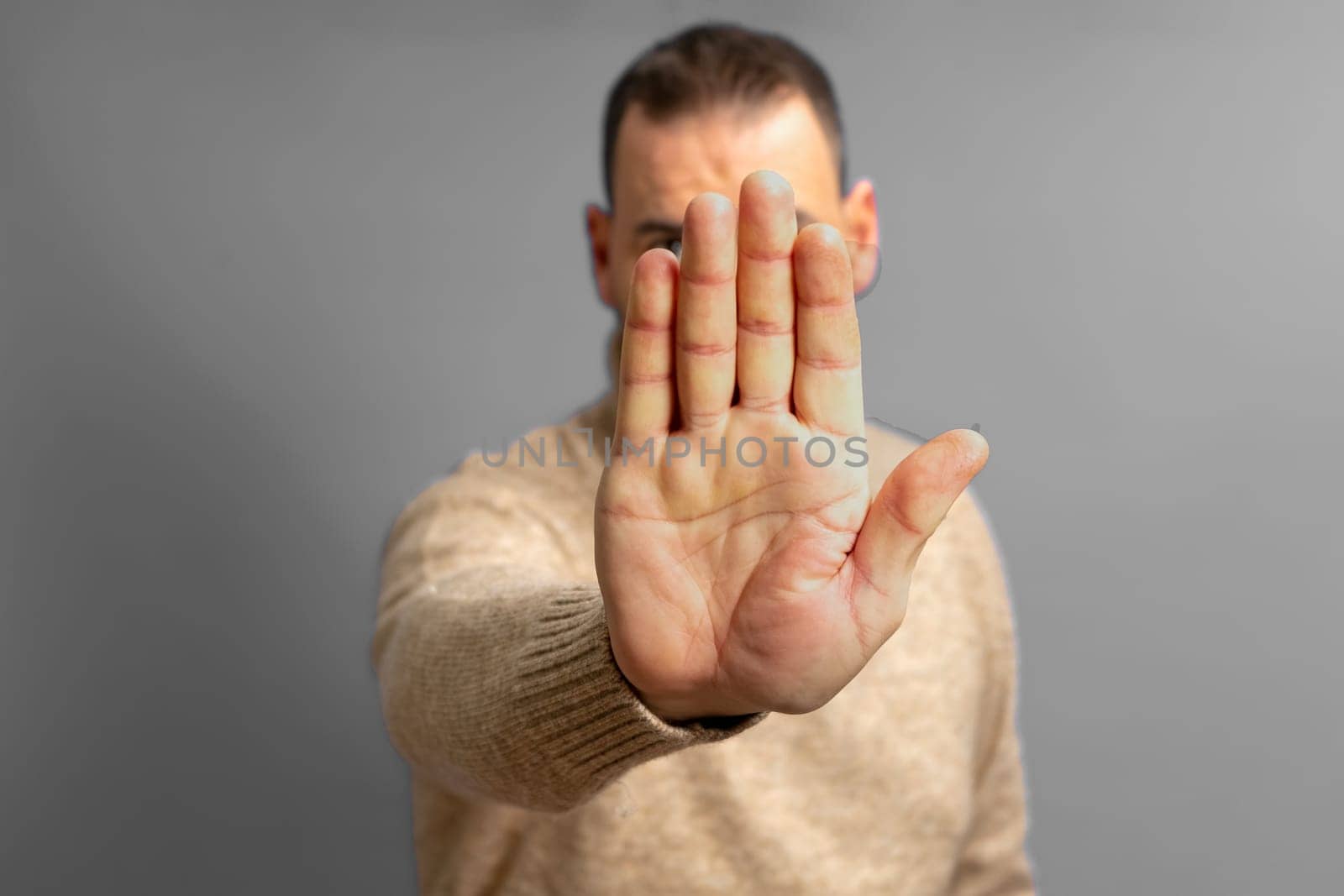 Hispanic man showing hands and palm lines forward with blurred body, man demonstrating hand strength. Concept of stop, strength, hands and DNA, five fingers on the hand