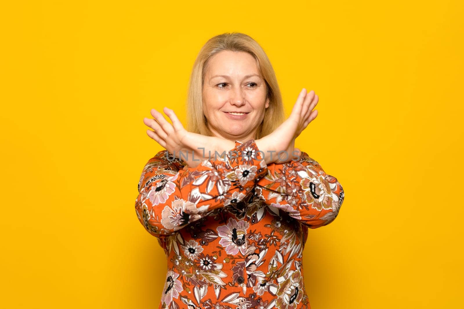 Stop don't move, Portrait of blonde caucasian woman cross hands x sign reject choice decisions wear good looking outfit isolated over yellow color background. by Barriolo82