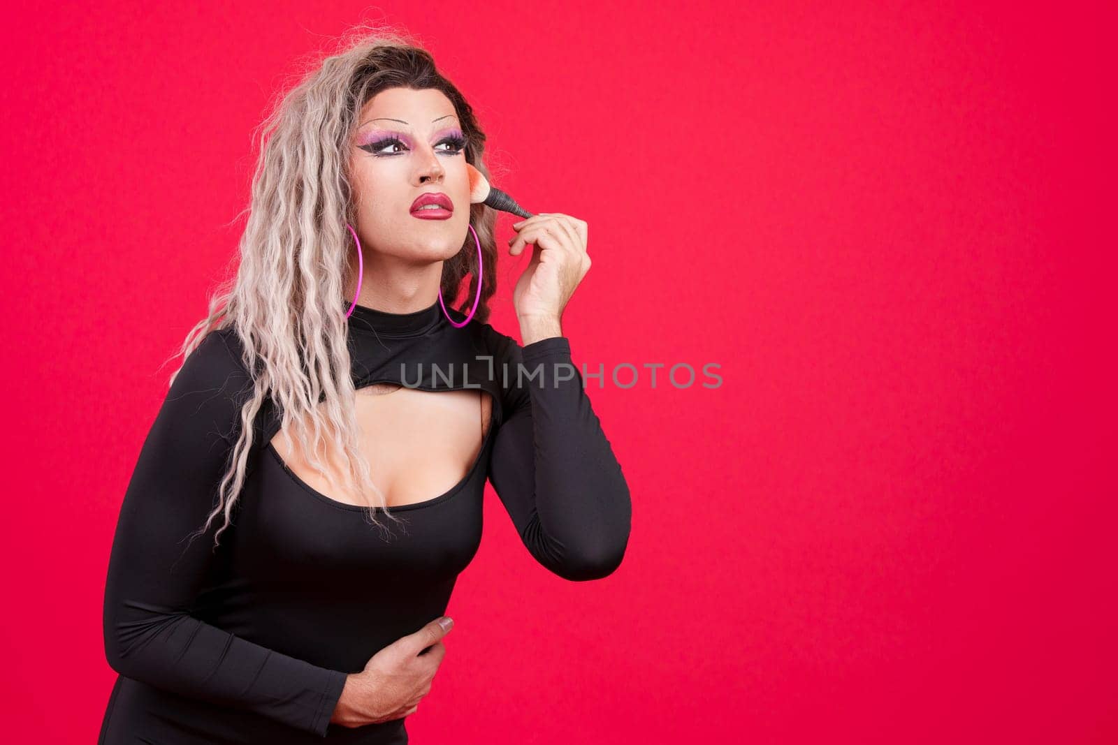 Transgender person dressed as drag queen making up by ivanmoreno