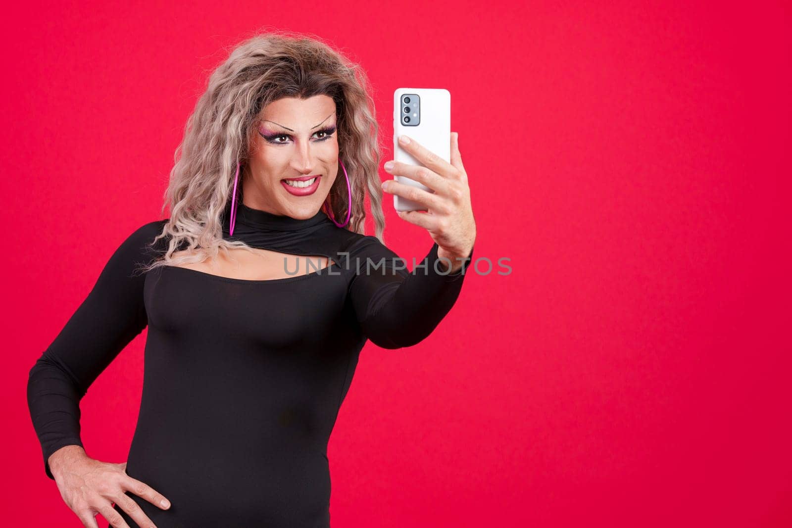 Transgender woman with make up taking a selfie with a mobile phone