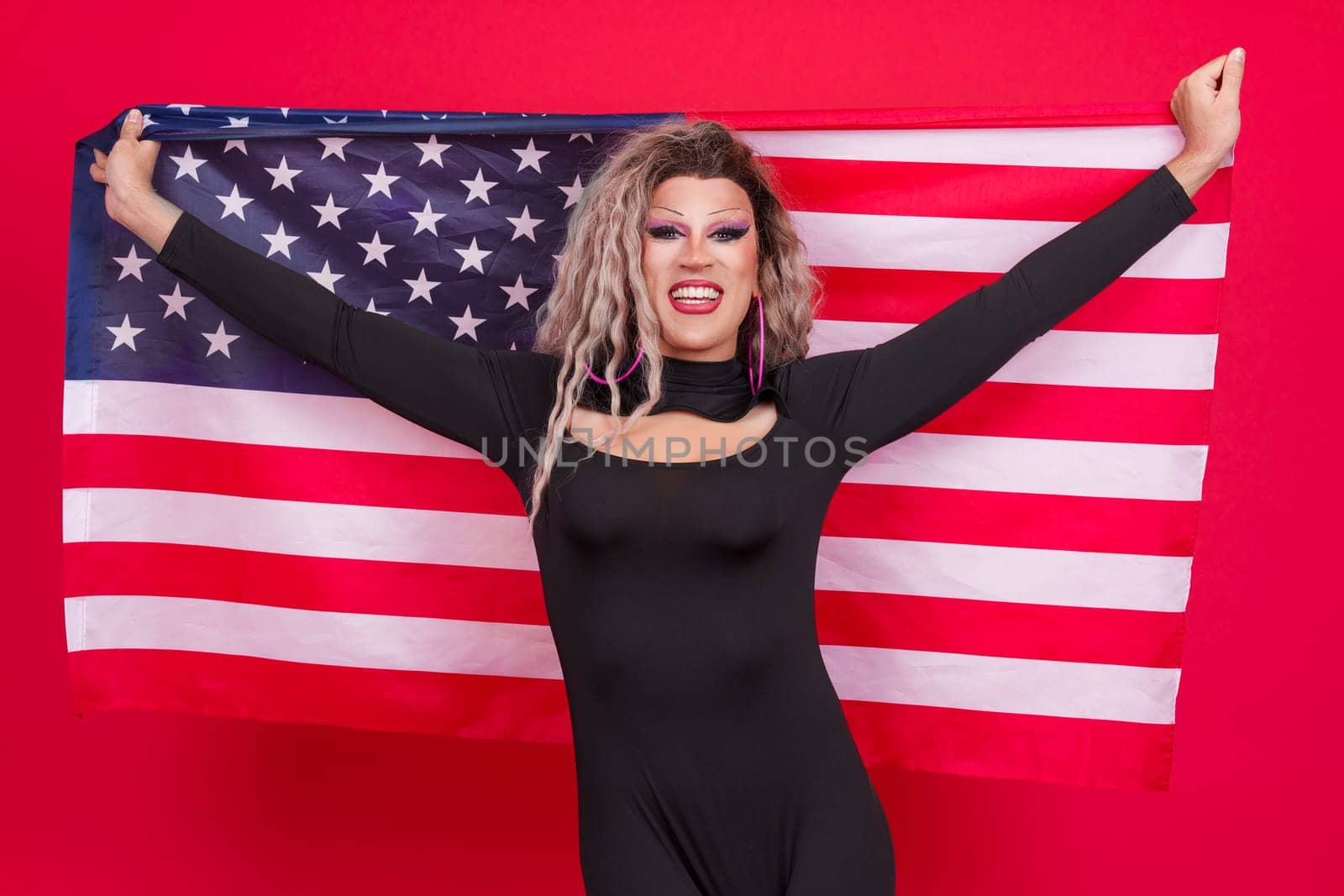 Happy transgender person raising a north america national flag by ivanmoreno