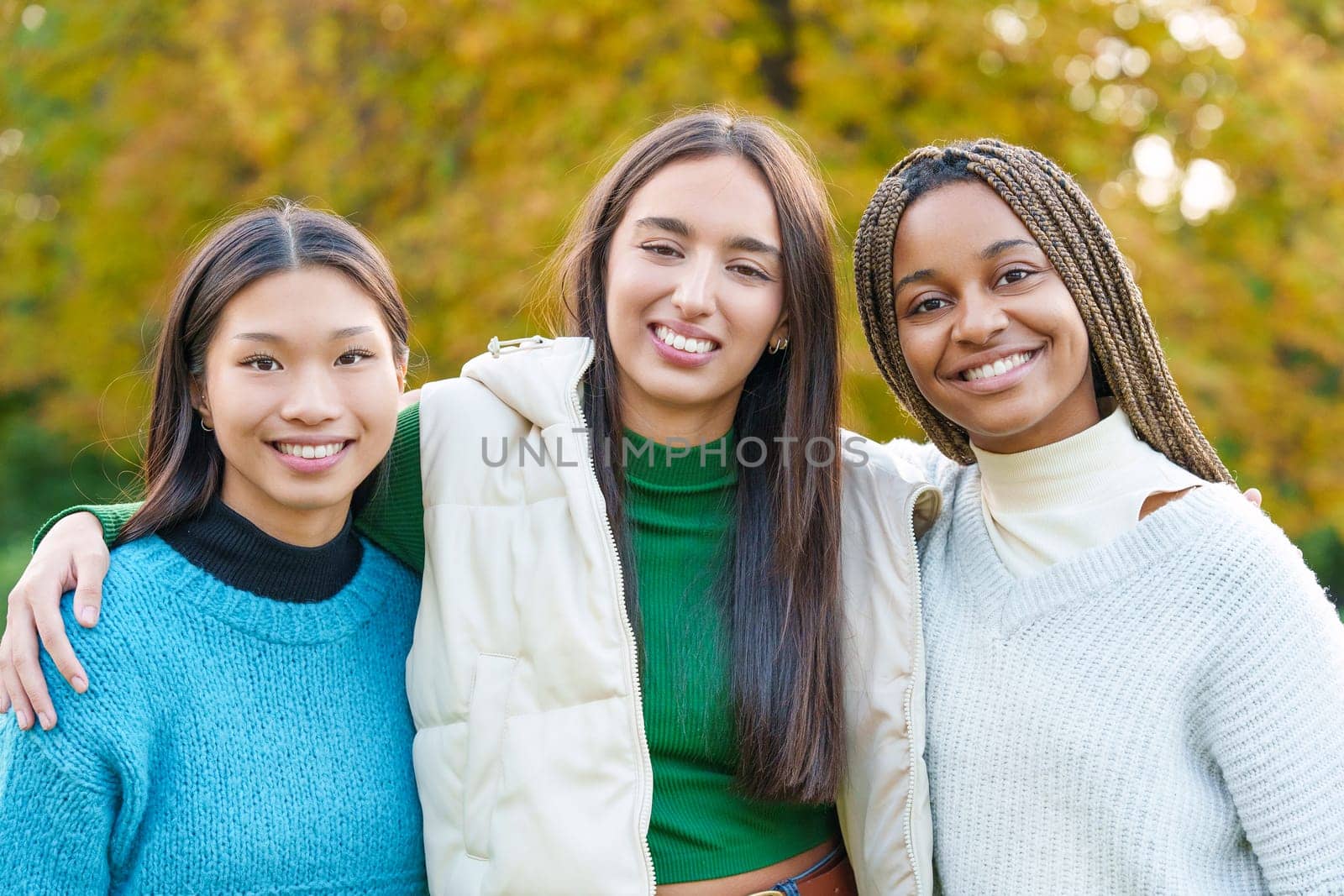 Portrait of multiethnic friends looking at the camera and smiling in the park