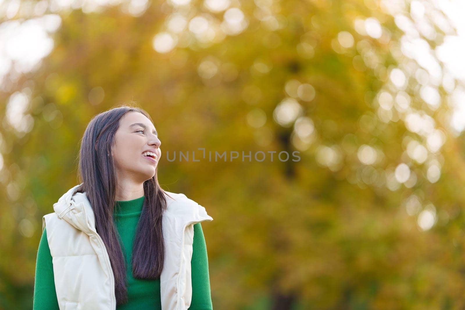 Photo with copy space and focus on a happy caucasian young woman in a park