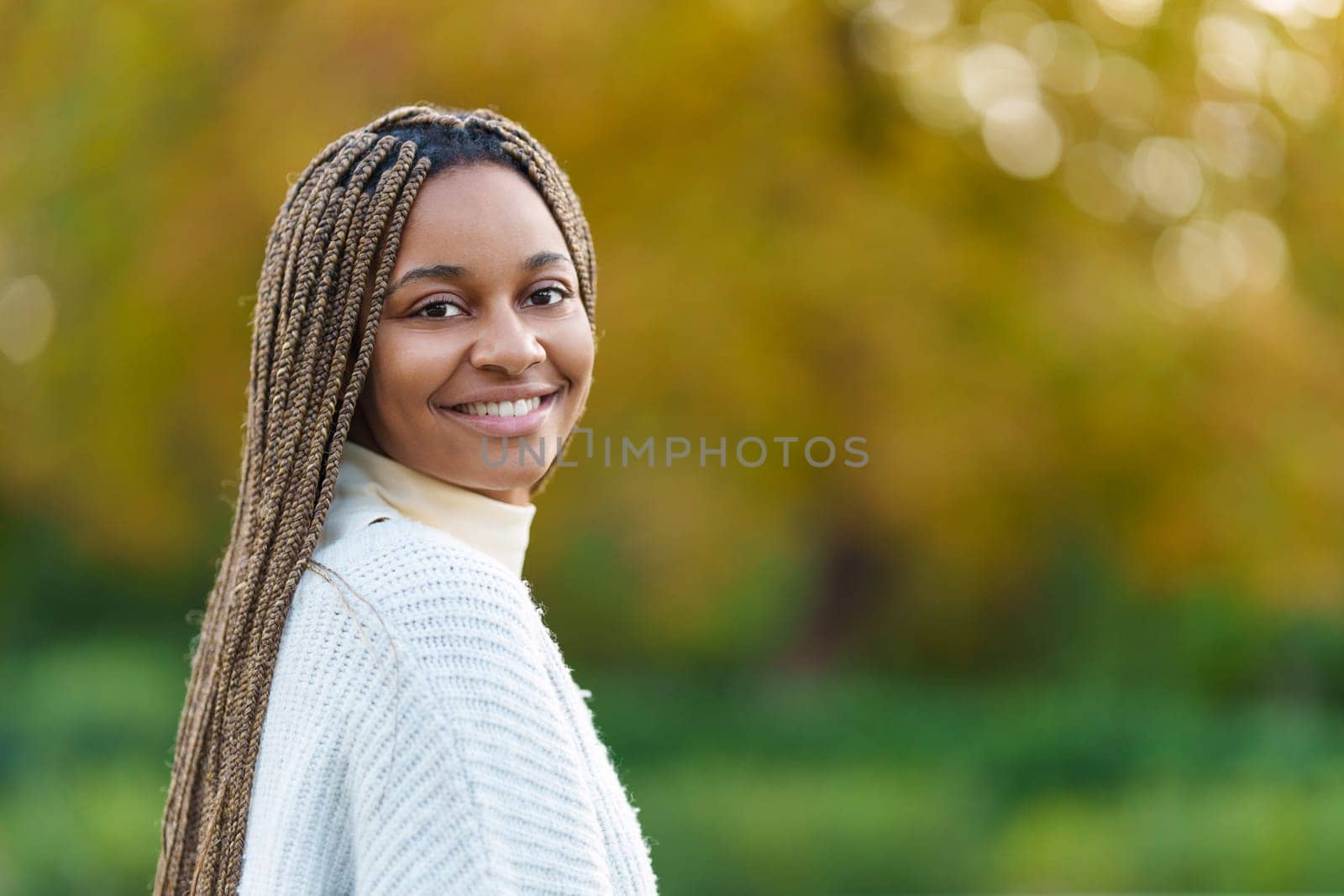 Photo with copy space of an african woman turning to smile at the camera