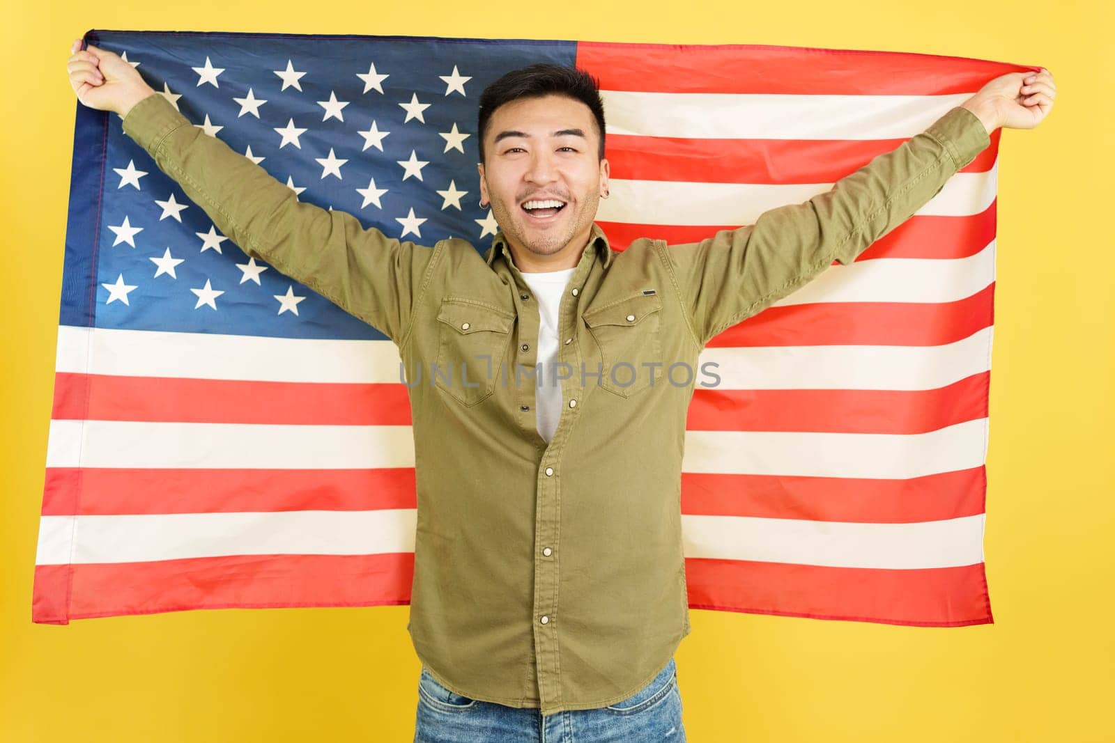 Happy chinese man raising a USA national flag by ivanmoreno