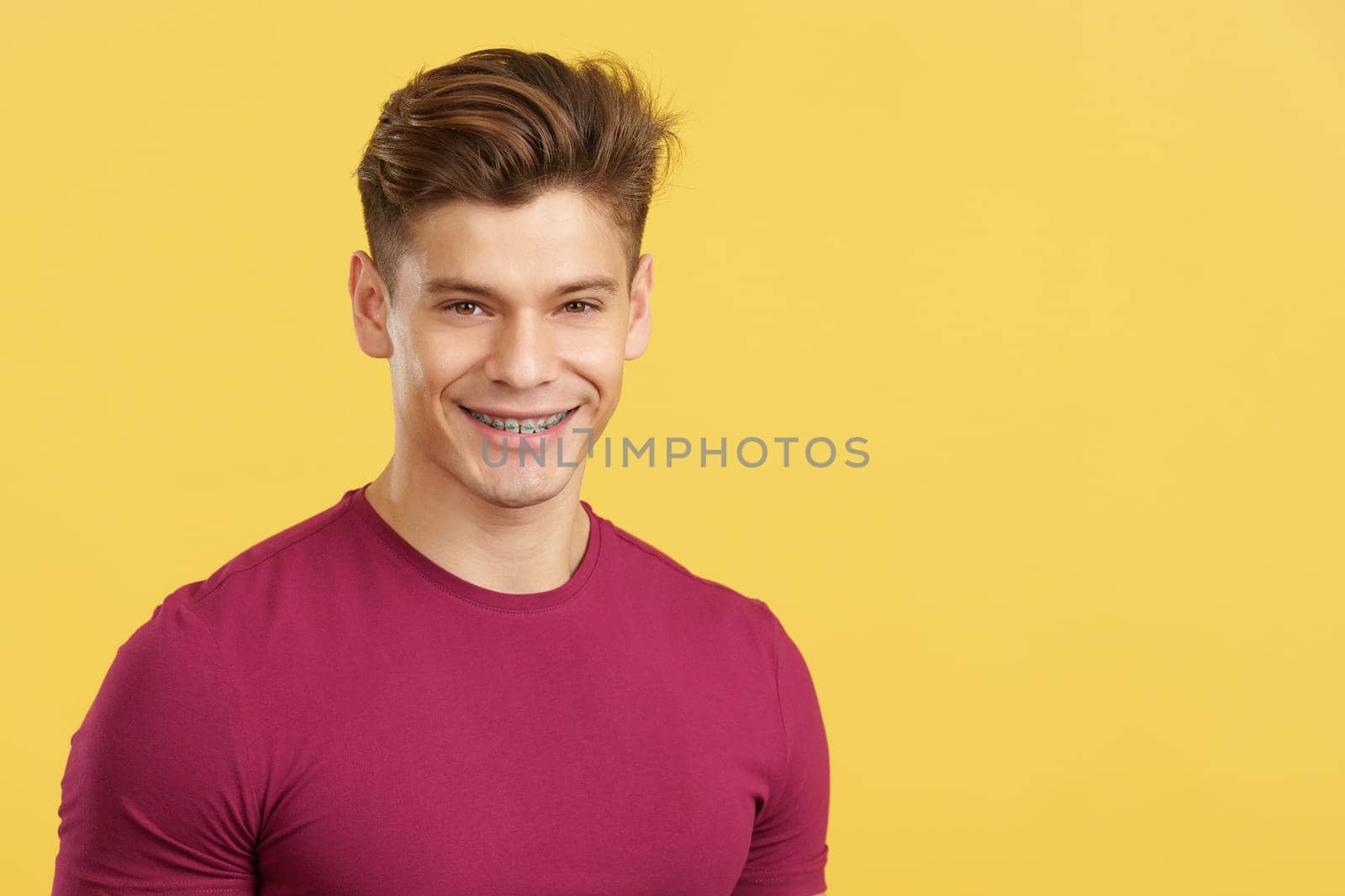 Caucasian man smiling while wearing brackets on his teeth by ivanmoreno