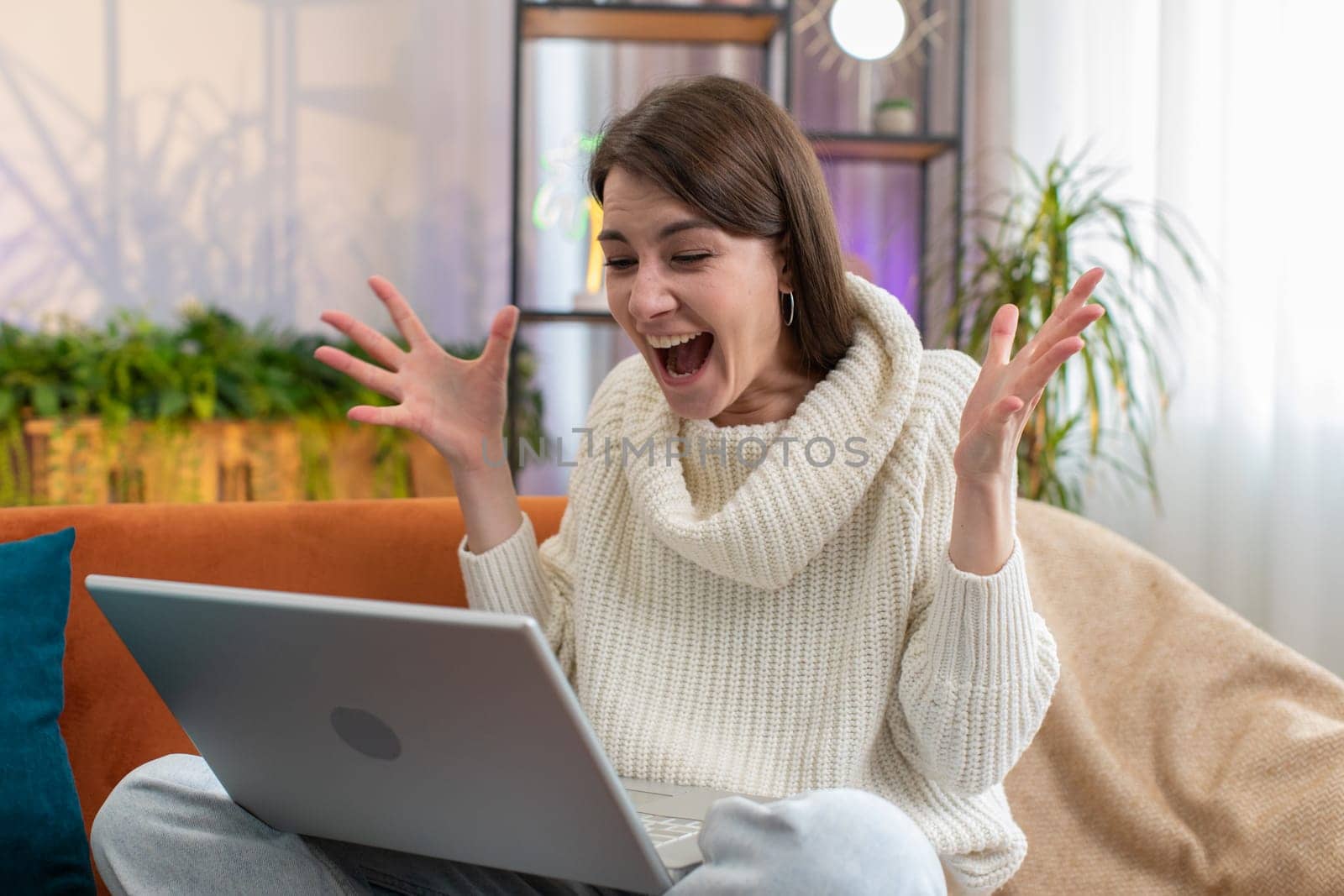 Oh my God Wow. Surprised young woman using laptop computer, receive good news message, shocked by sudden victory celebrate lottery jackpot win purchases online shopping at home. Lifestyle technologies