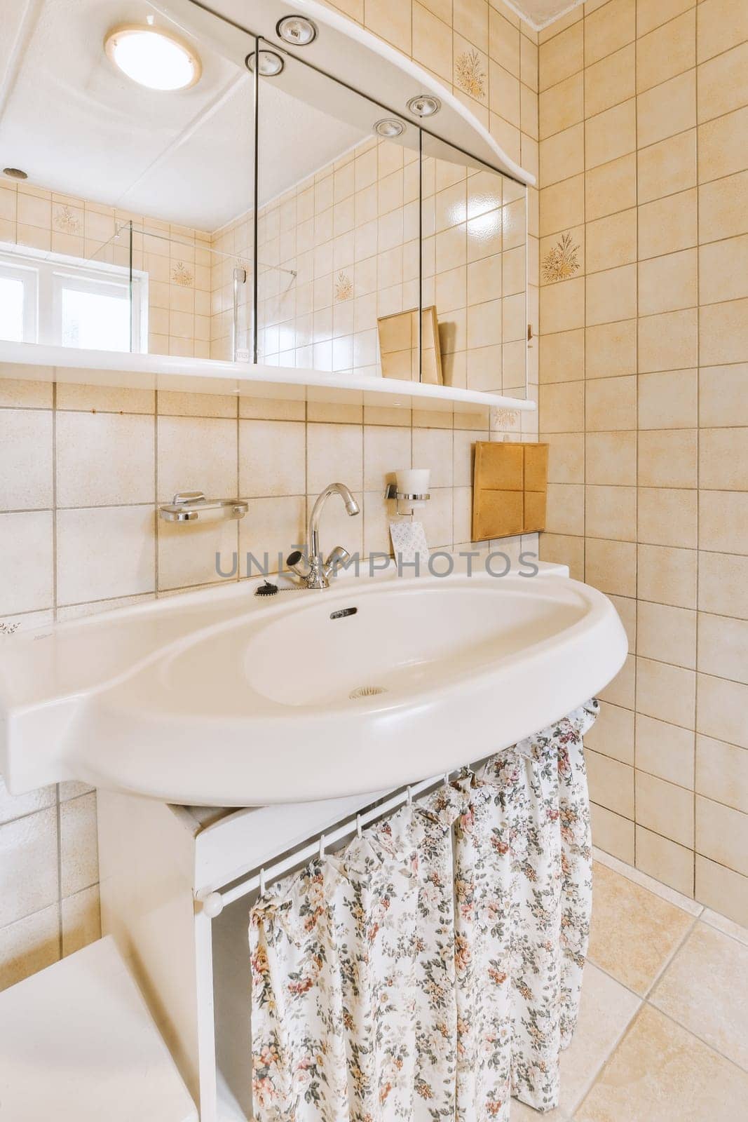 a bathroom with a sink, mirror and toilet paper on the wall in this photo is taken from above it