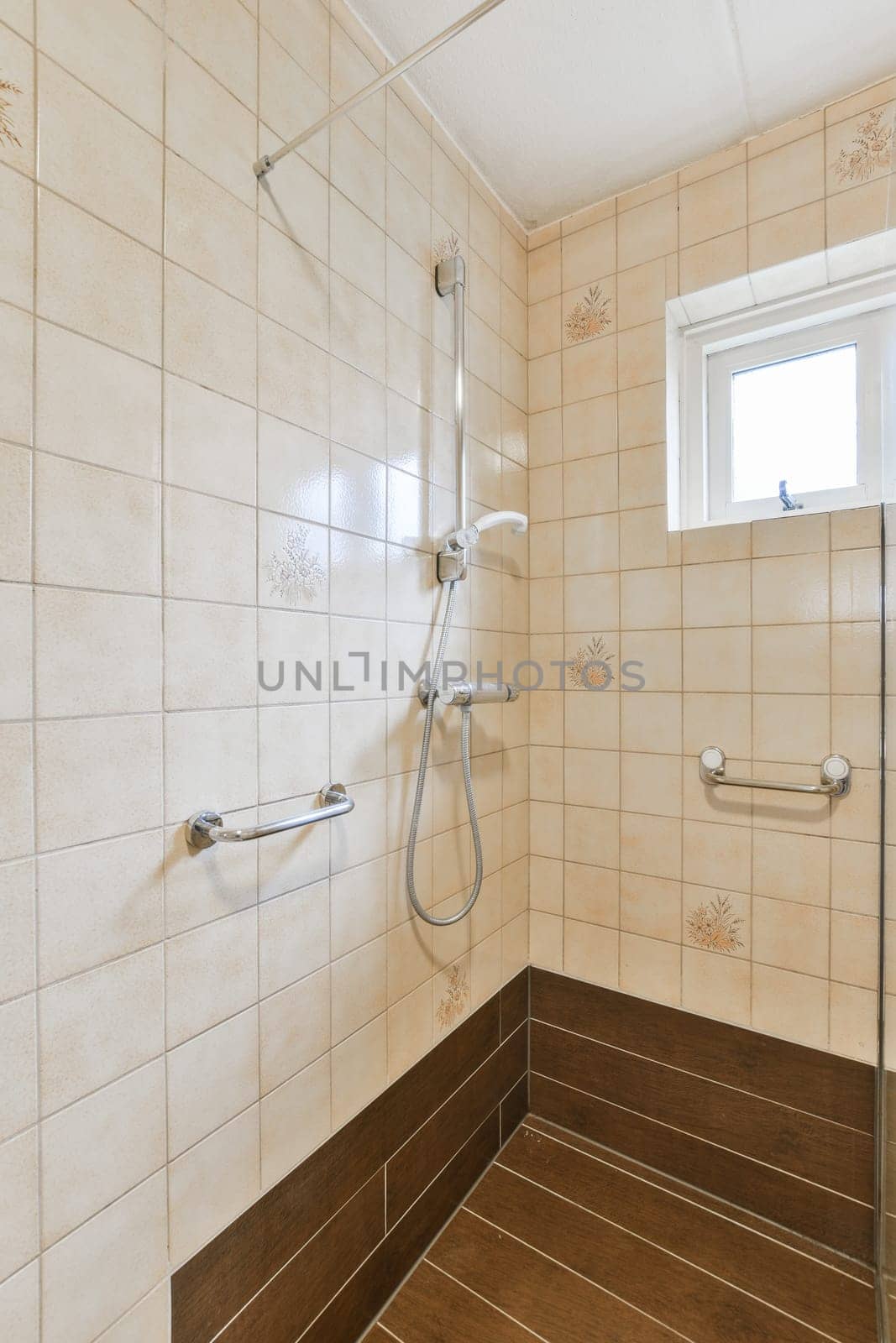a bathroom with tile on the floor and shower head mounted to the wall, in front of a large window