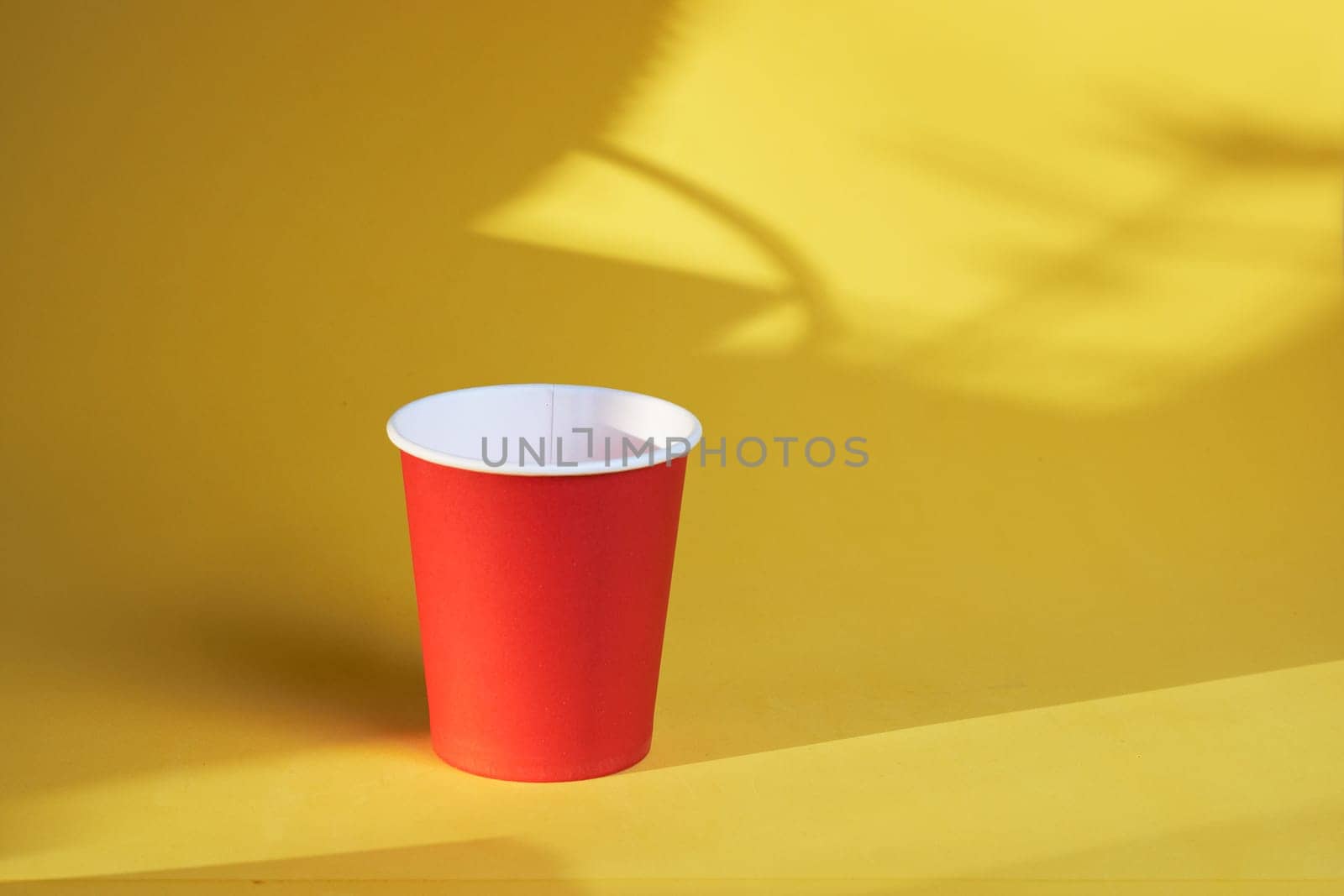 Paper coffee container on a yellow background Red Coffee paper Cup on a yellow background Takeaway Coffee