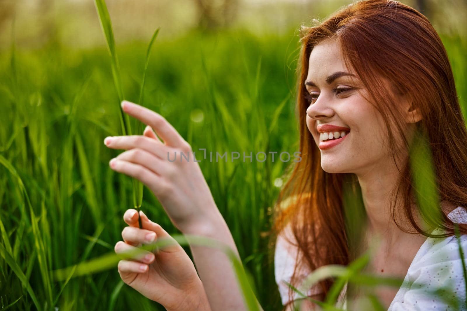woman resting sitting in tall grass on a sunny day. High quality photo