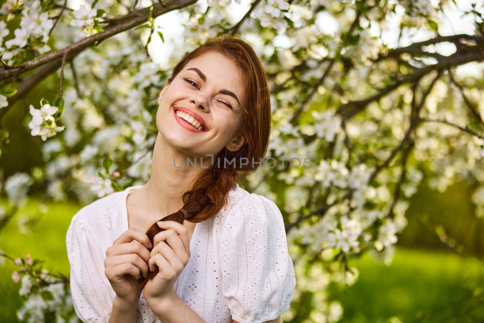 beautiful woman in blossom park smiling. High quality photo