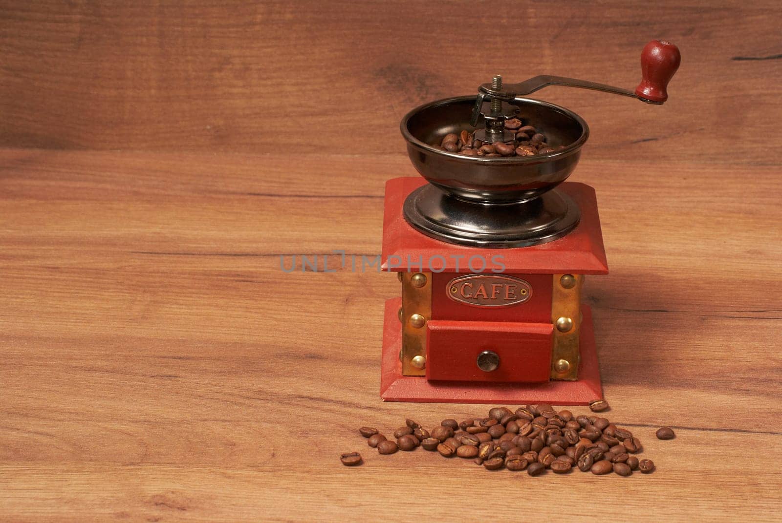Manual coffee grinder for grinding coffee beans. Wooden background. vintage coffee grinder coffee beans