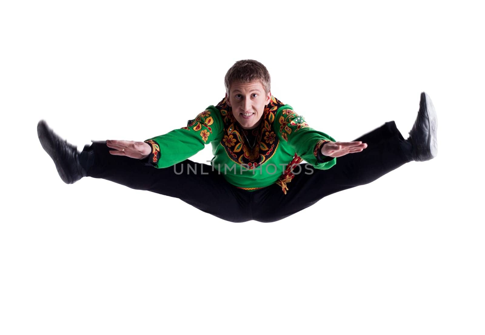 Young folk dancer posing in studio, isolated on white