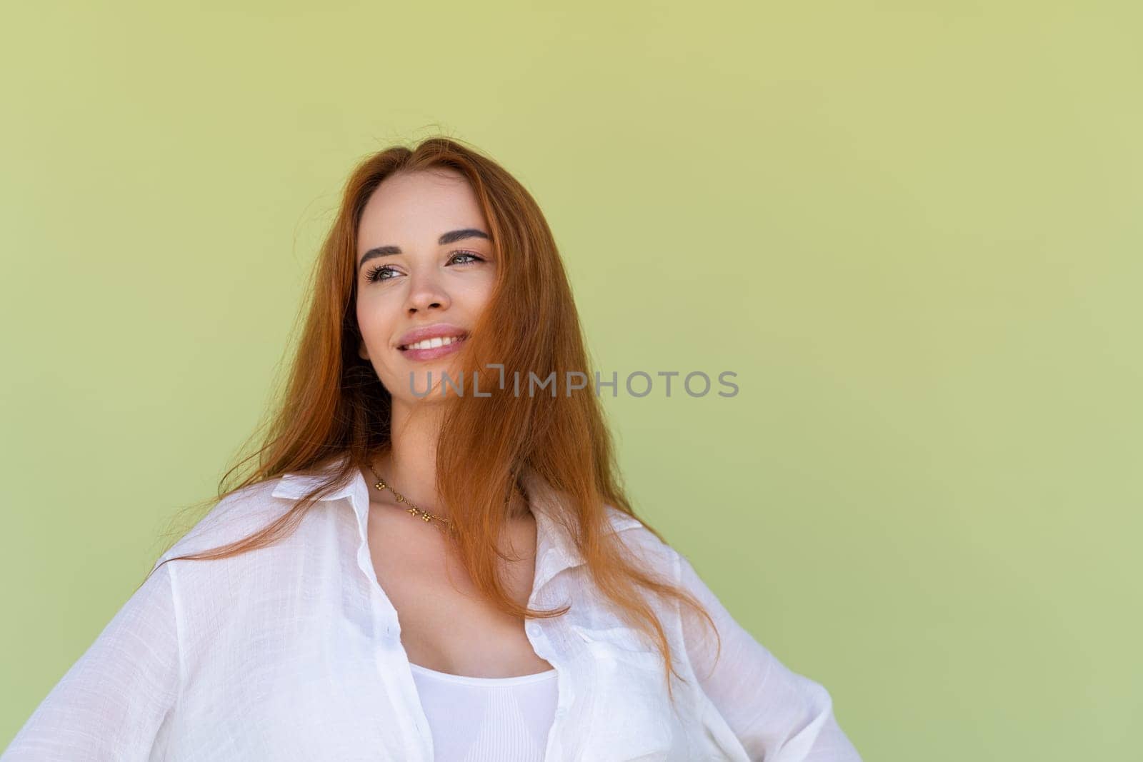 Beautiful long red hair woman in casual shirt on green background positive smiling laughing enjoying exited by kroshka_nastya