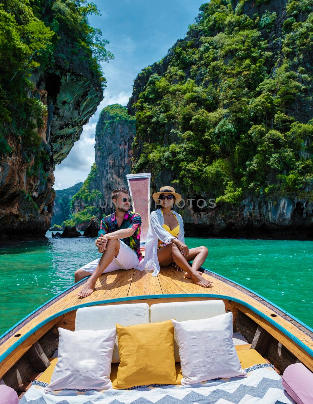 Luxury Longtail boat in Krabi Thailand, couple man and woman on a trip at the tropical island 4 Island trip in Krabi Thailand. Asian woman and European man mid age on vacation in Thailand by fokkebok