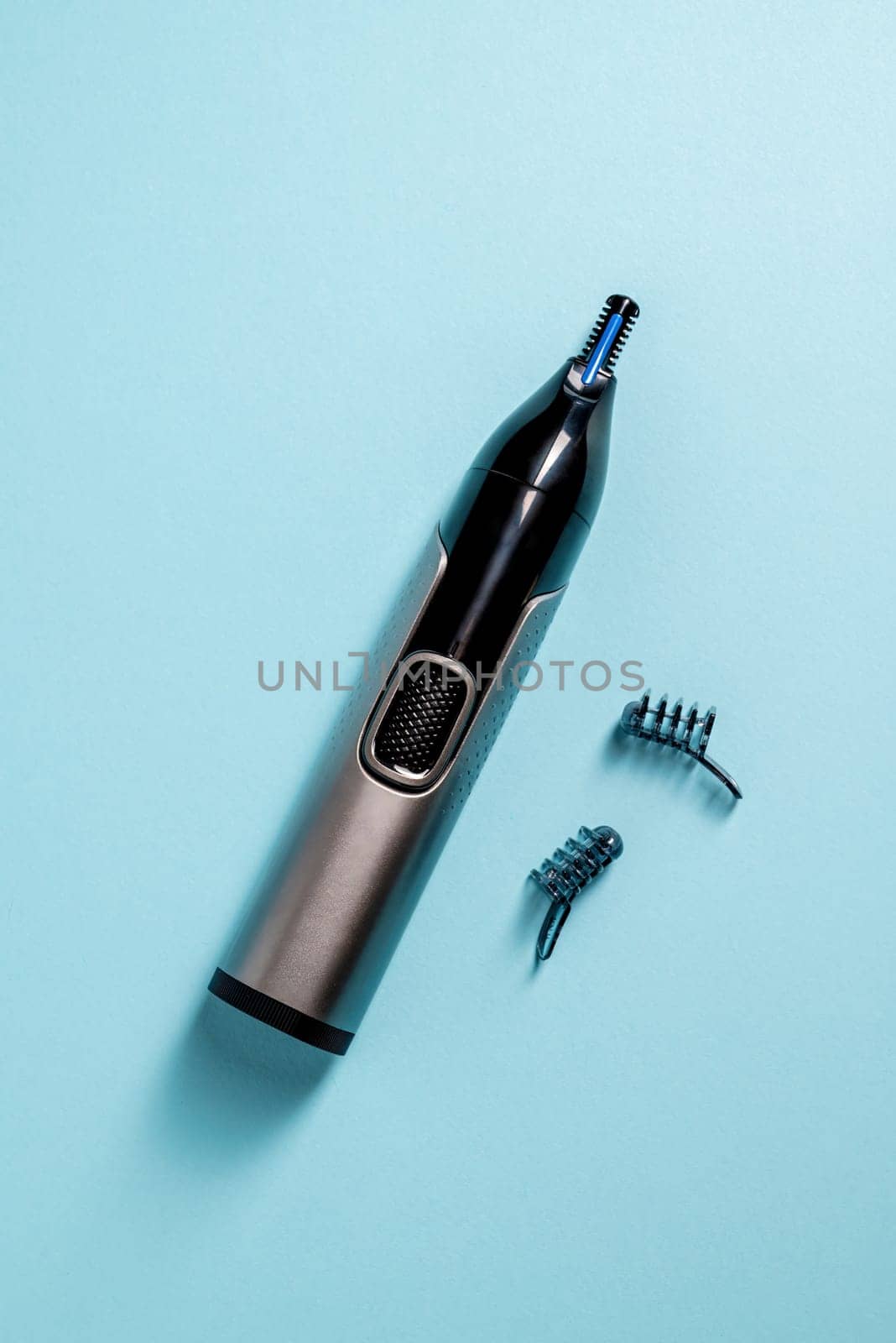 Top view of nose and ear hair trimmer isolated on blue background