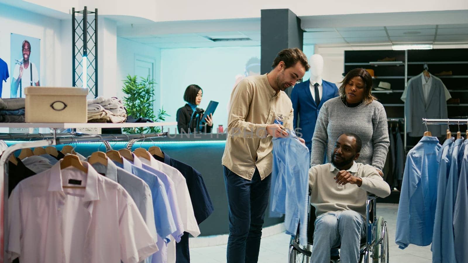 Young person with physical disability checking clothes by DCStudio