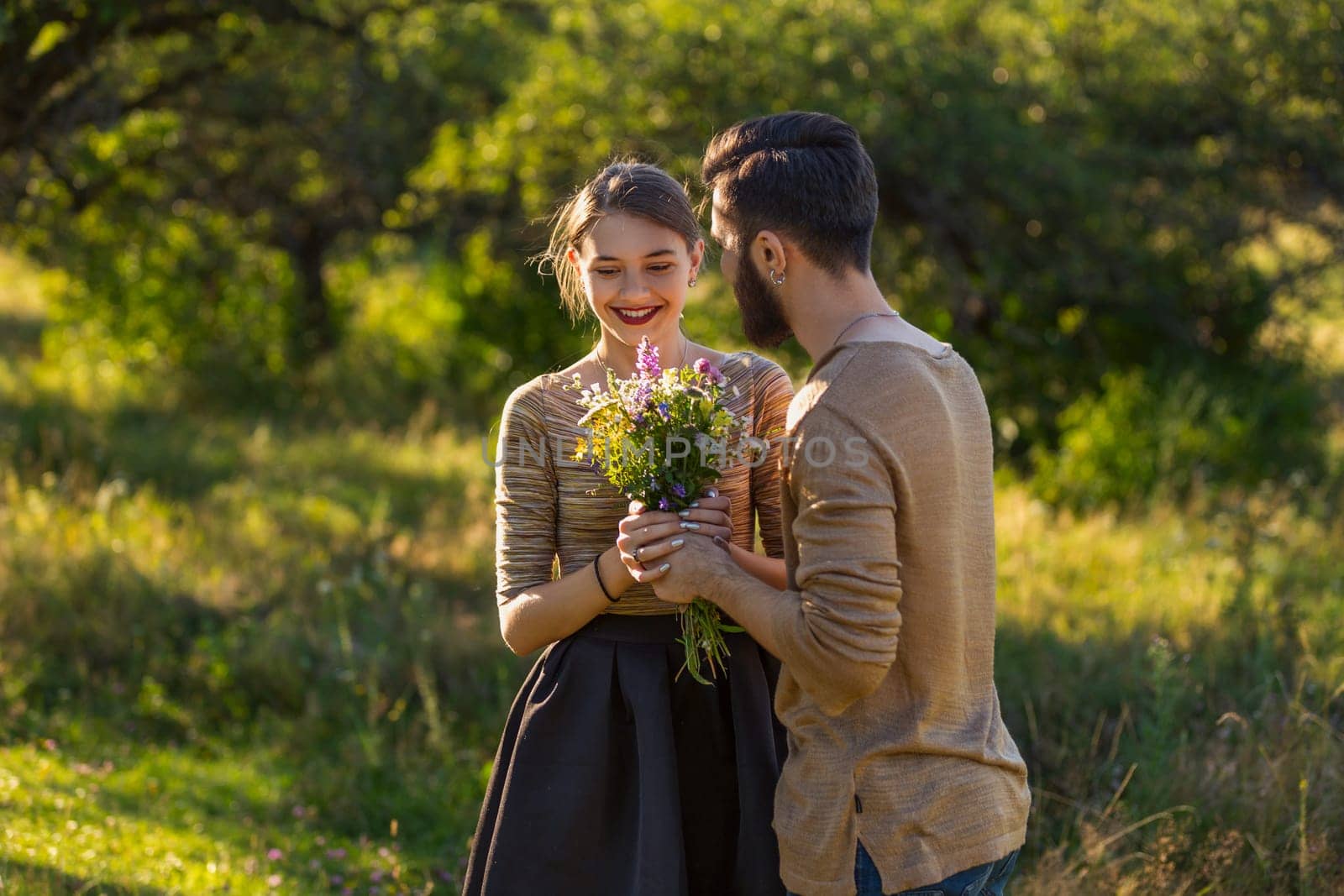 man giving wild flowers to his girlfriend